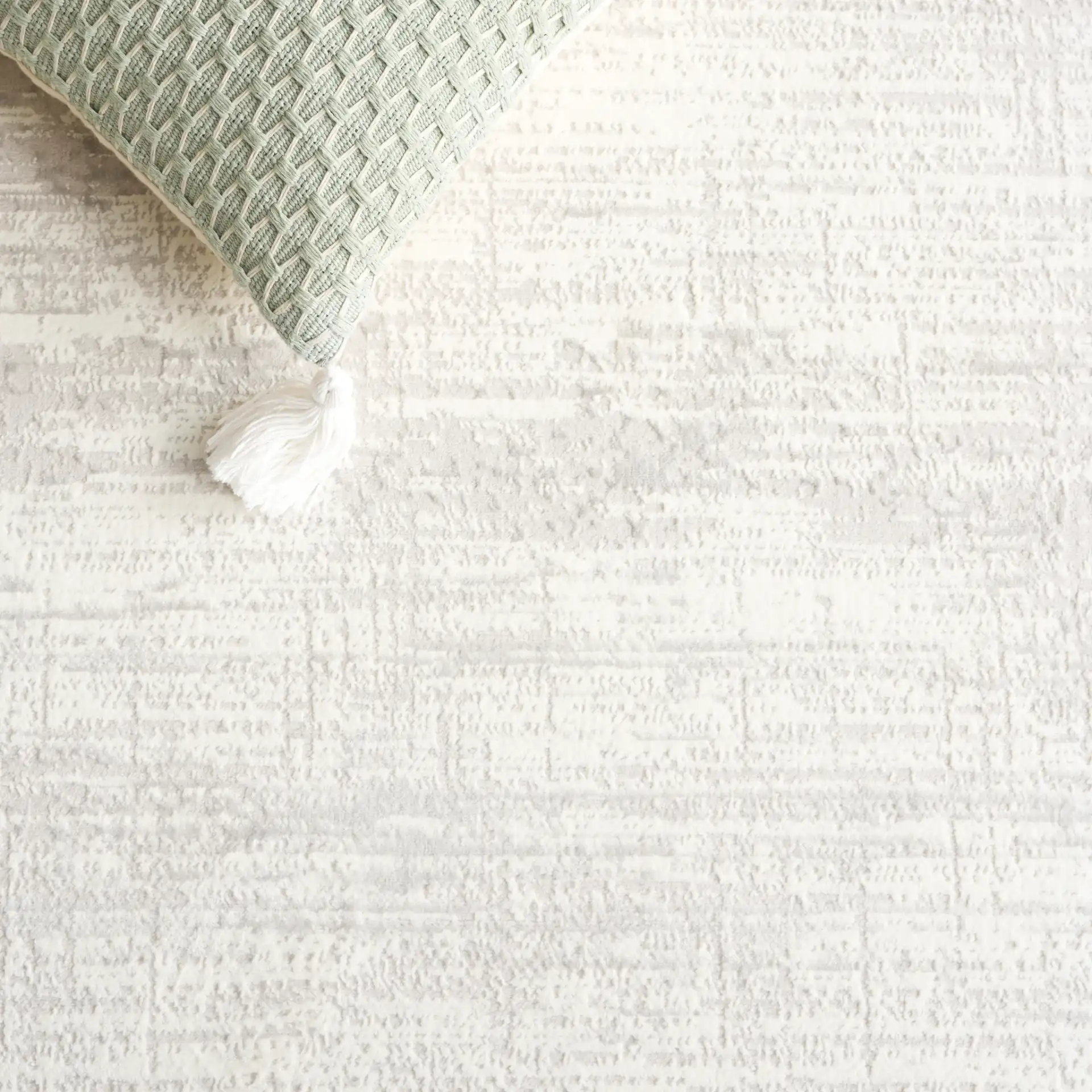 Memphis Bordered Textured Rug in Gray / Ivory in a styled room