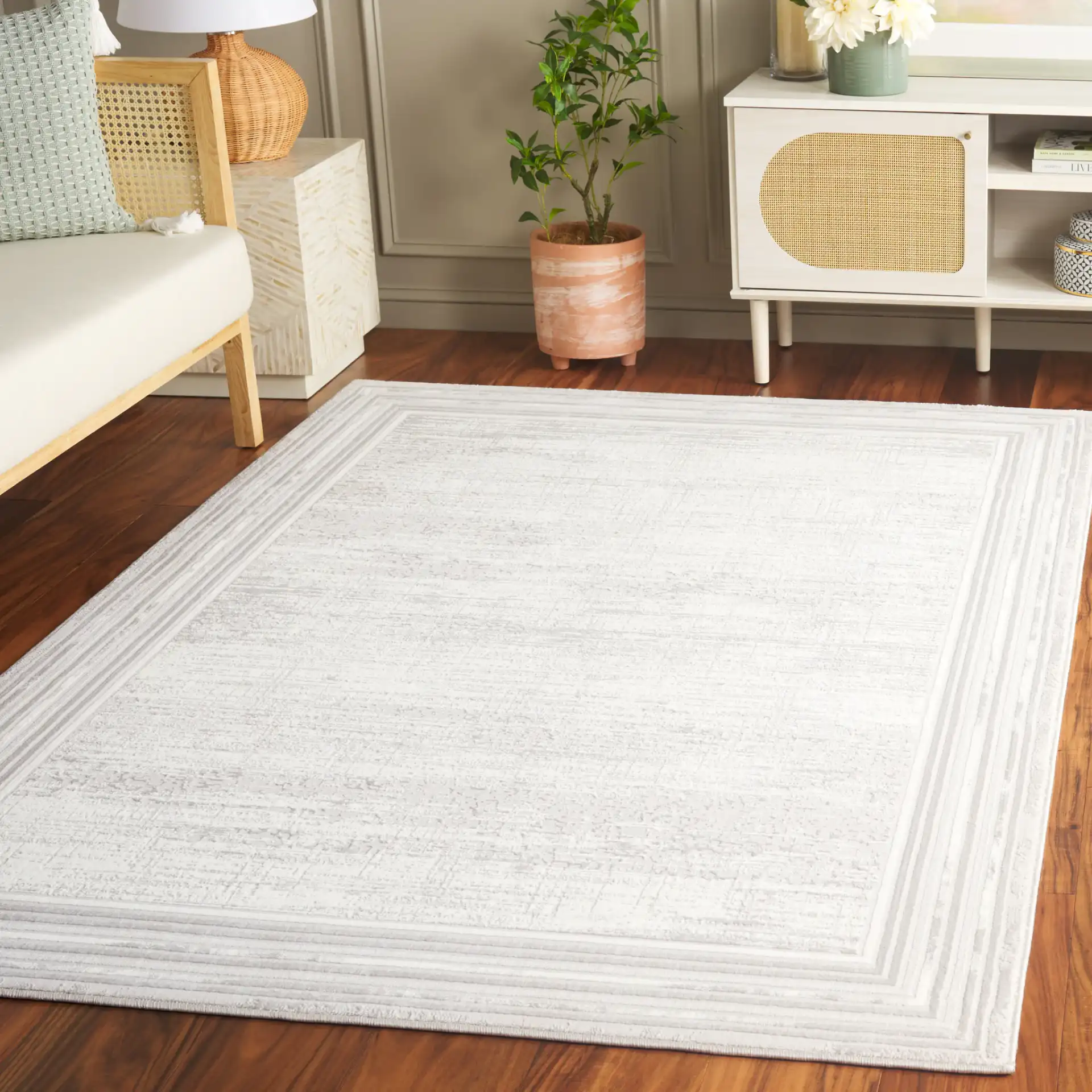 Memphis Bordered Textured Rug in Gray / Ivory in a styled room