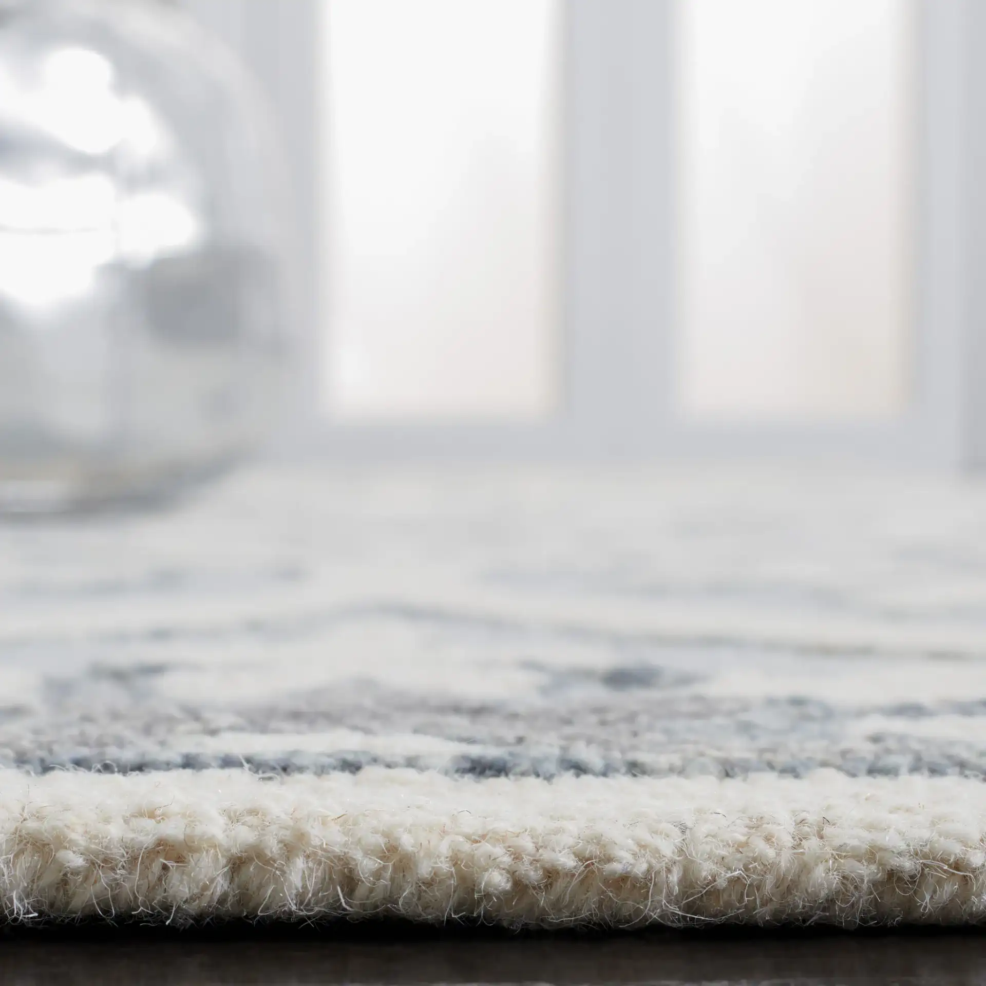 Metro Ogee Medallion Hand-Tufted Wool Rug in Gray / Ivory in a styled room