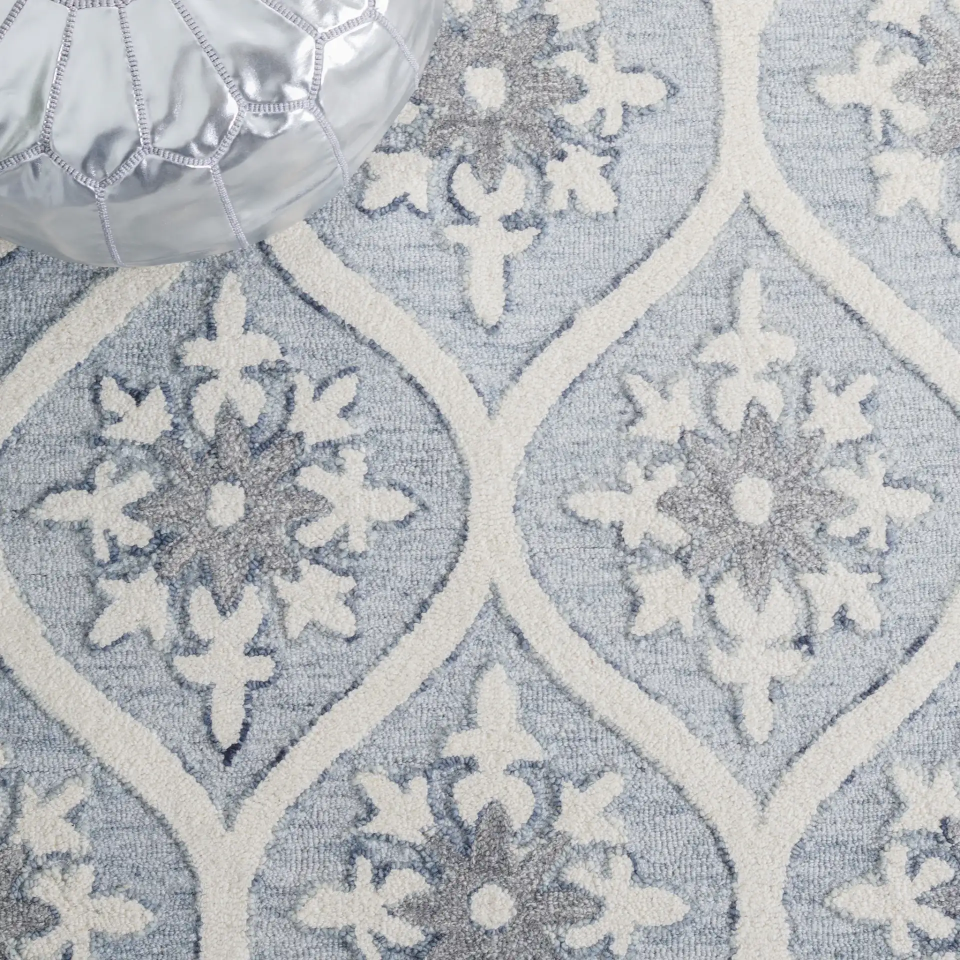 Metro Ogee Medallion Hand-Tufted Wool Rug in Gray / Ivory in a styled room