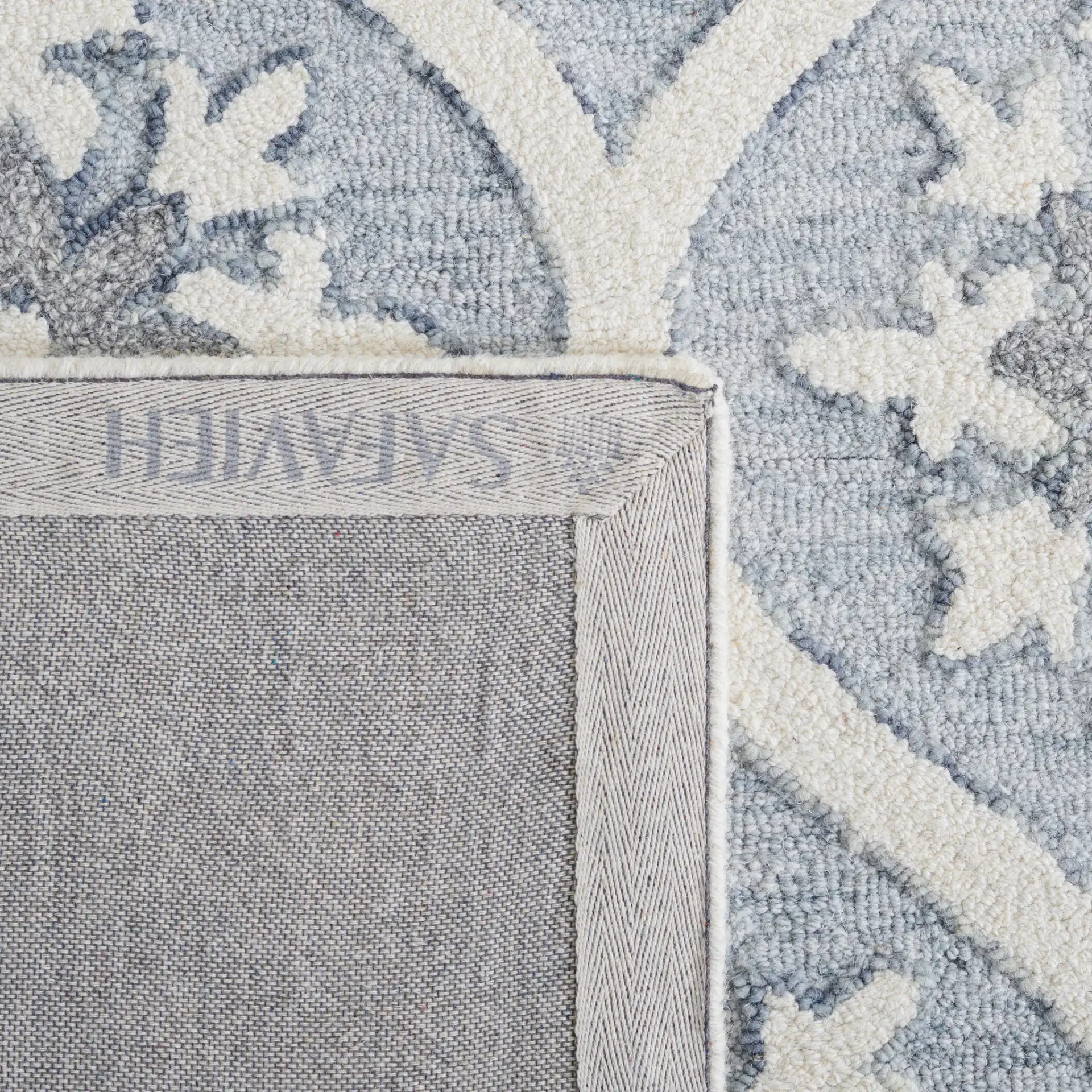 Metro Ogee Medallion Hand-Tufted Wool Rug in Gray / Ivory in a styled room