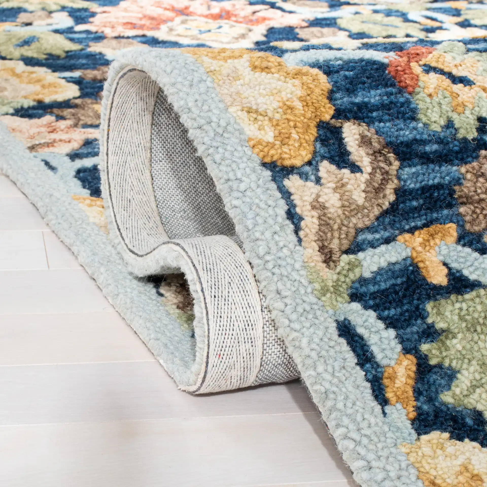 Metro Allover Floral Hand-Tufted Wool Rug in Blue / Orange in a styled room