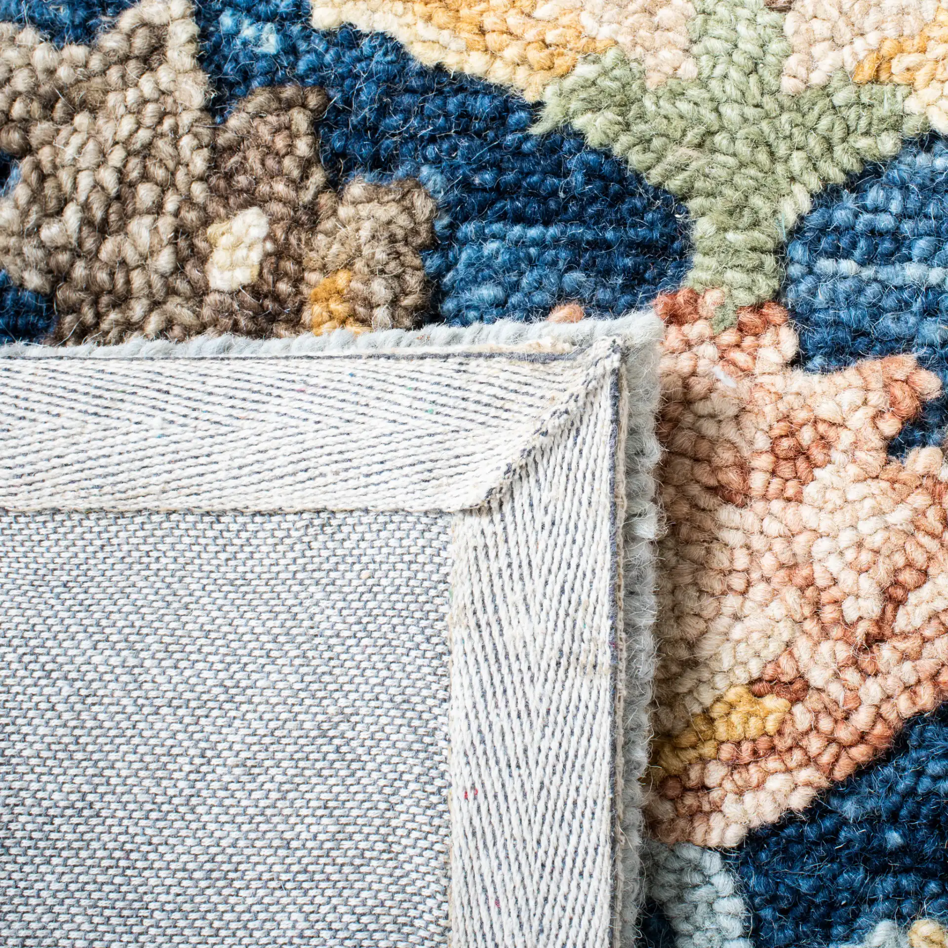 Metro Allover Floral Hand-Tufted Wool Rug in Blue / Orange in a styled room