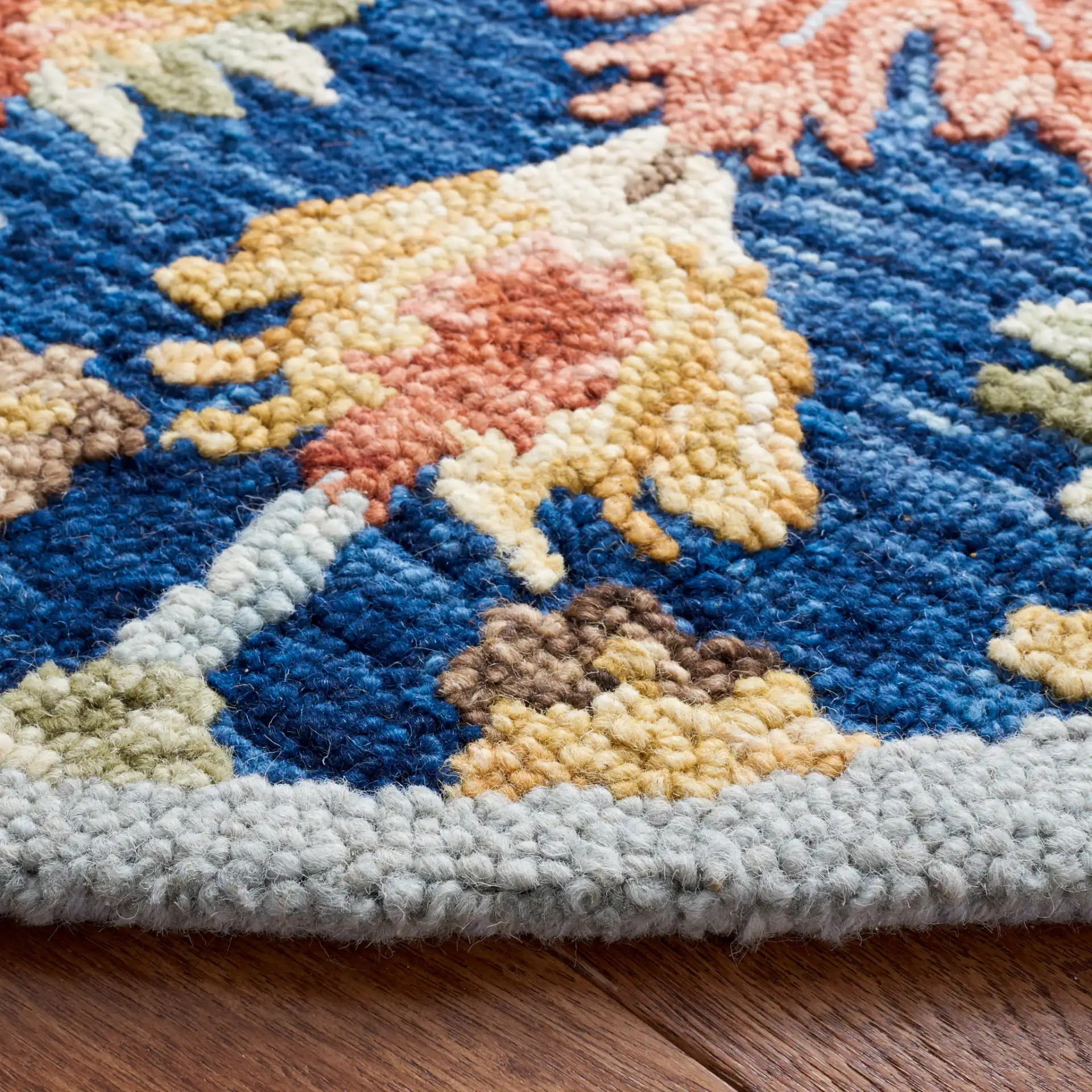Metro Allover Floral Hand-Tufted Wool Rug in Blue / Orange in a styled room
