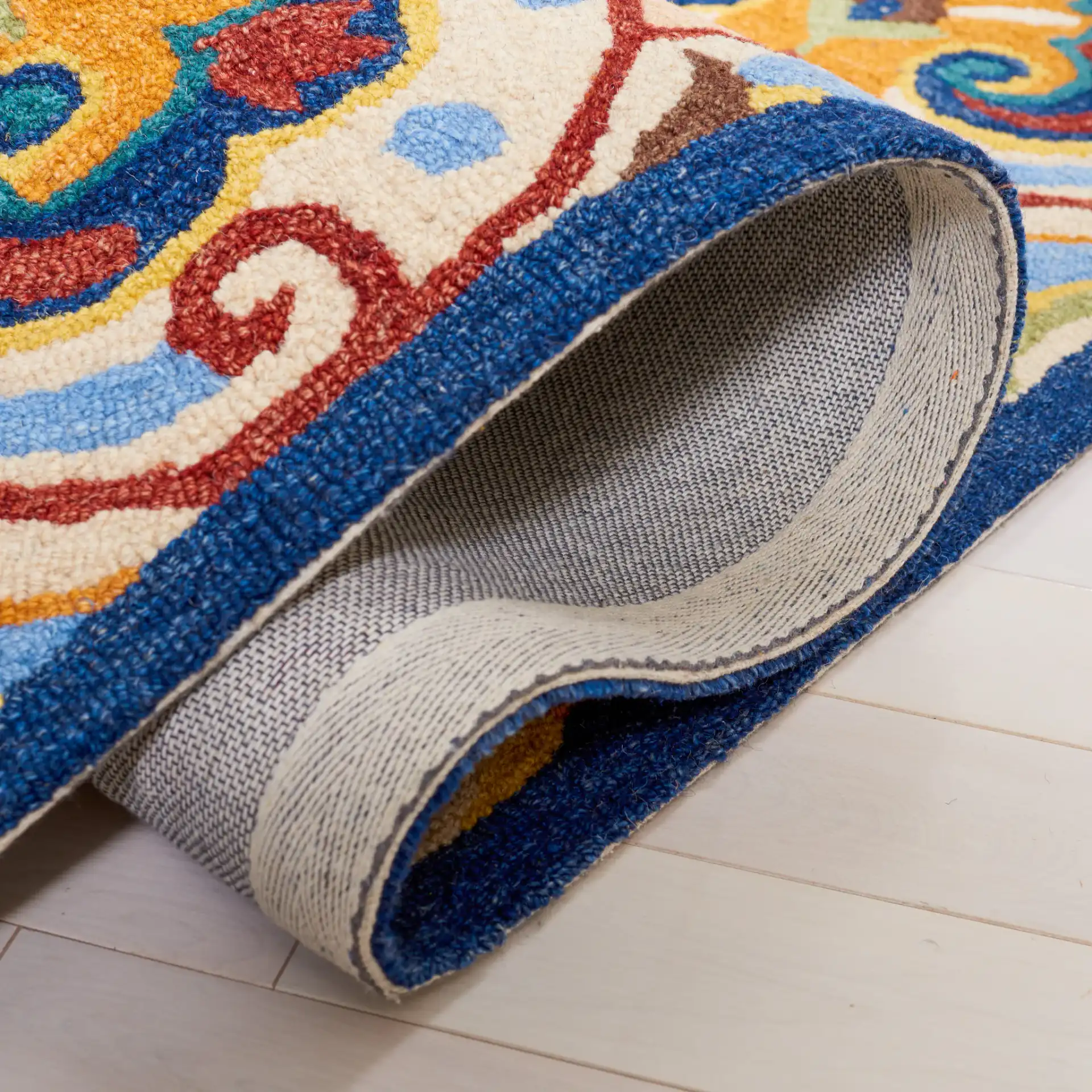 Metro Damask Scroll Trellis Hand-Tufted Wool Rug in Beige / Blue in a styled room