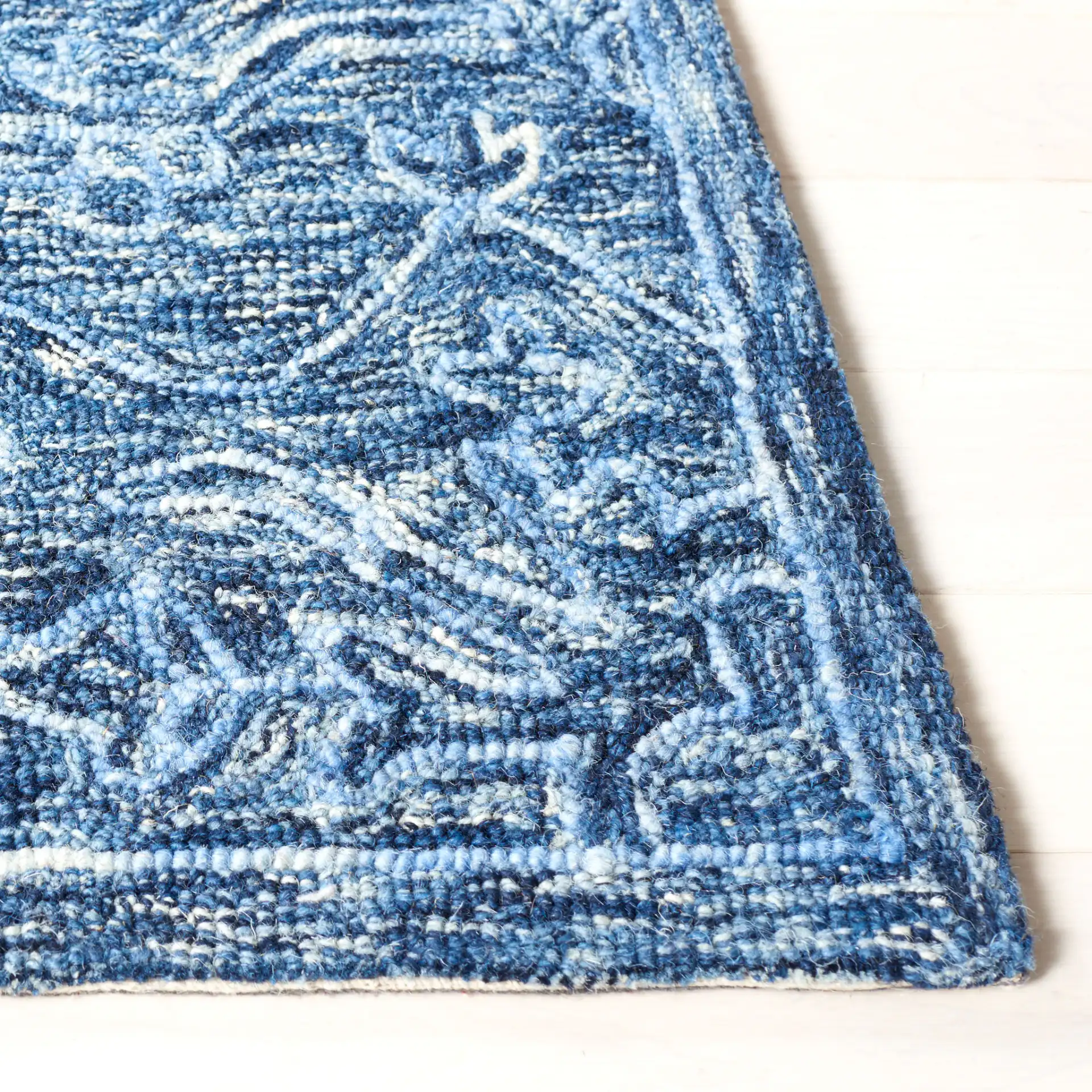 Metro Stepped Floral Medallion Hand-Tufted Wool Rug in Blue in a styled room