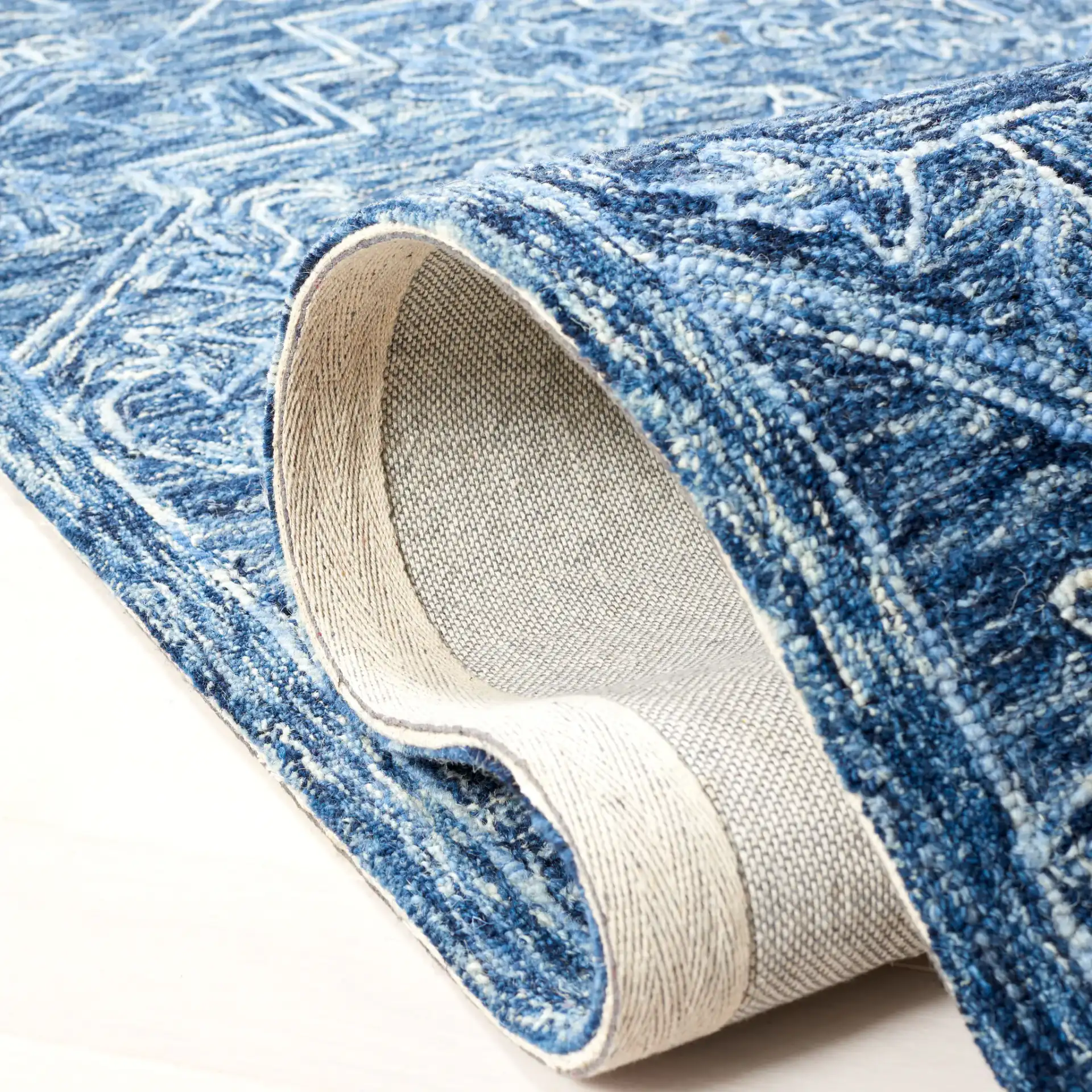 Metro Stepped Floral Medallion Hand-Tufted Wool Rug in Blue in a styled room