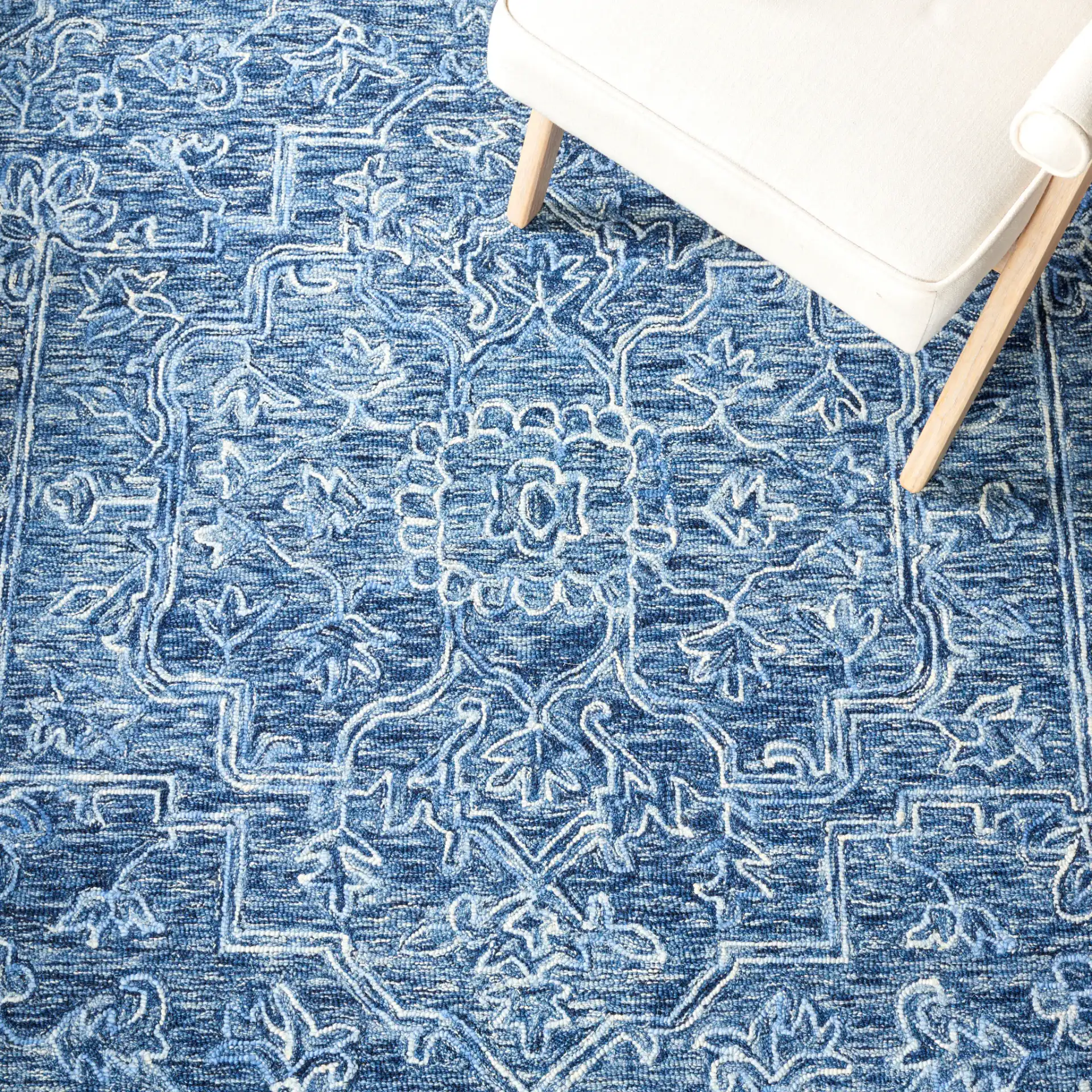 Metro Stepped Floral Medallion Hand-Tufted Wool Rug in Blue in a styled room