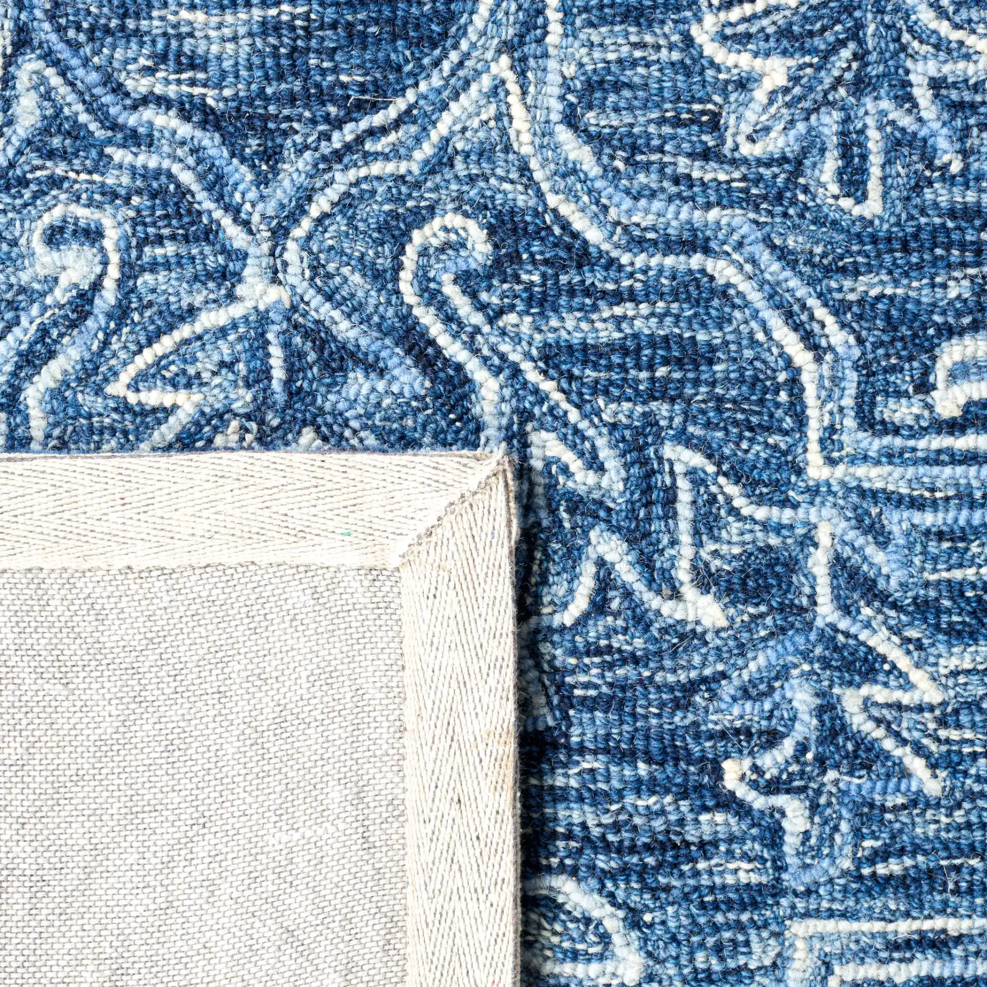 Metro Stepped Floral Medallion Hand-Tufted Wool Rug in Blue in a styled room