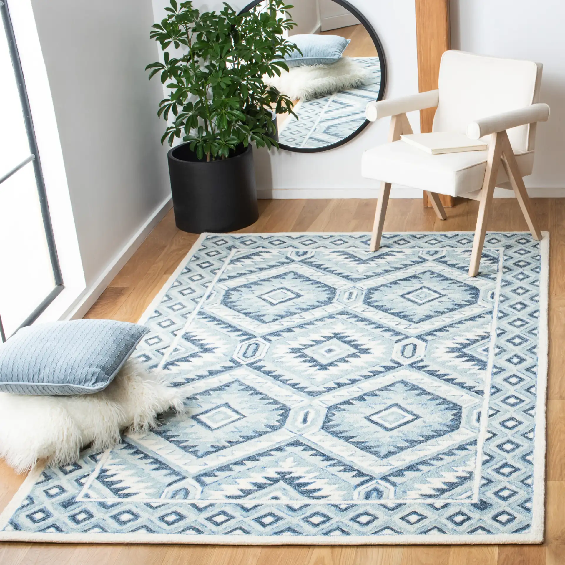 Metro Tribal Serrated Diamond Medallion Hand-Tufted Wool Rug in Blue / Ivory in a styled room