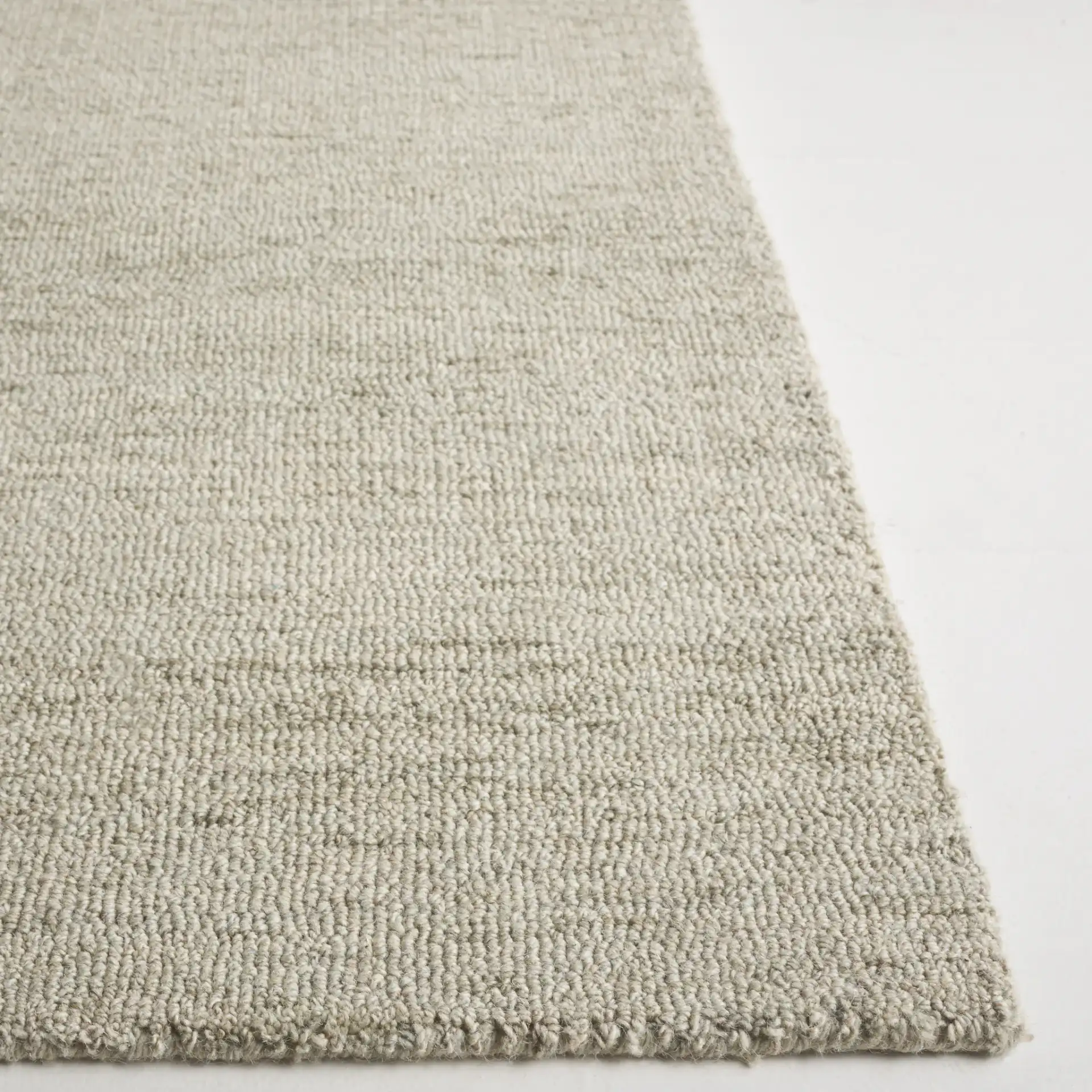 Metro Modern Heathered Hand-Tufted Wool Rug in Green in a styled room
