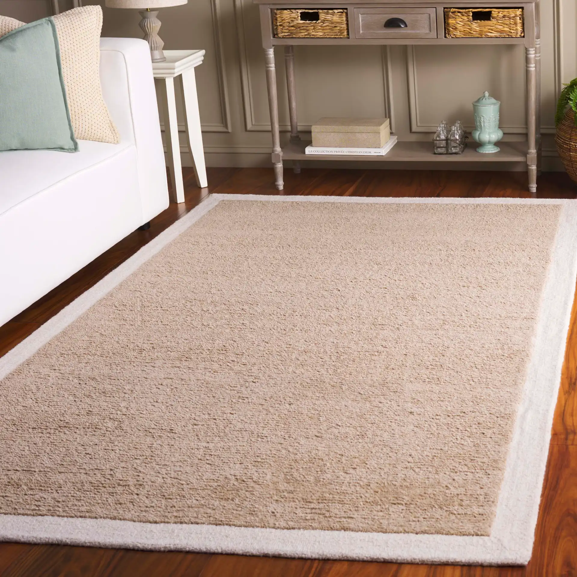 Metro Bordered Hand-Tufted Wool Rug in Beige / Ivory in a styled room