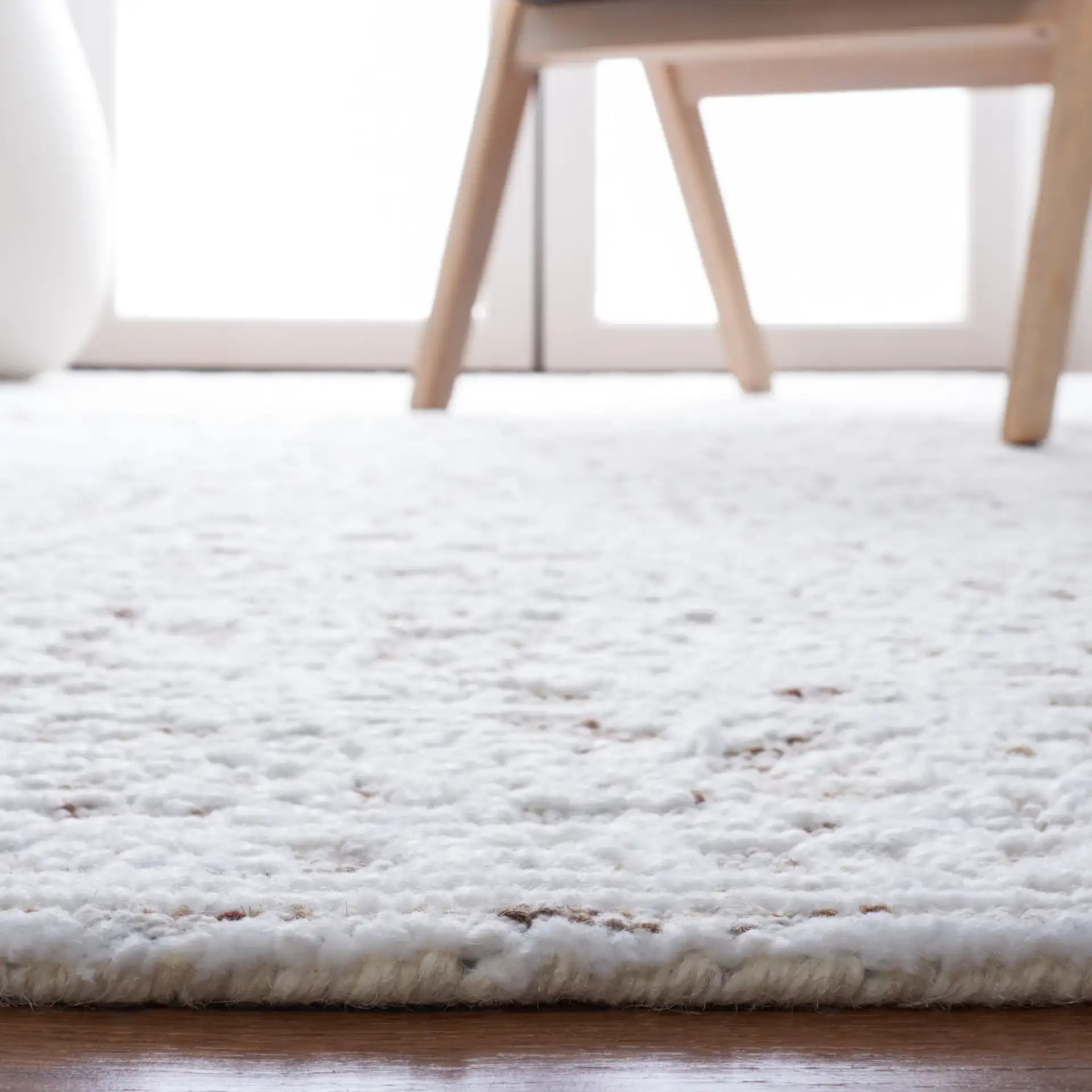 Metro Erased Medallion Hand-Tufted Wool Blend Rug in Ivory / Beige in a styled room