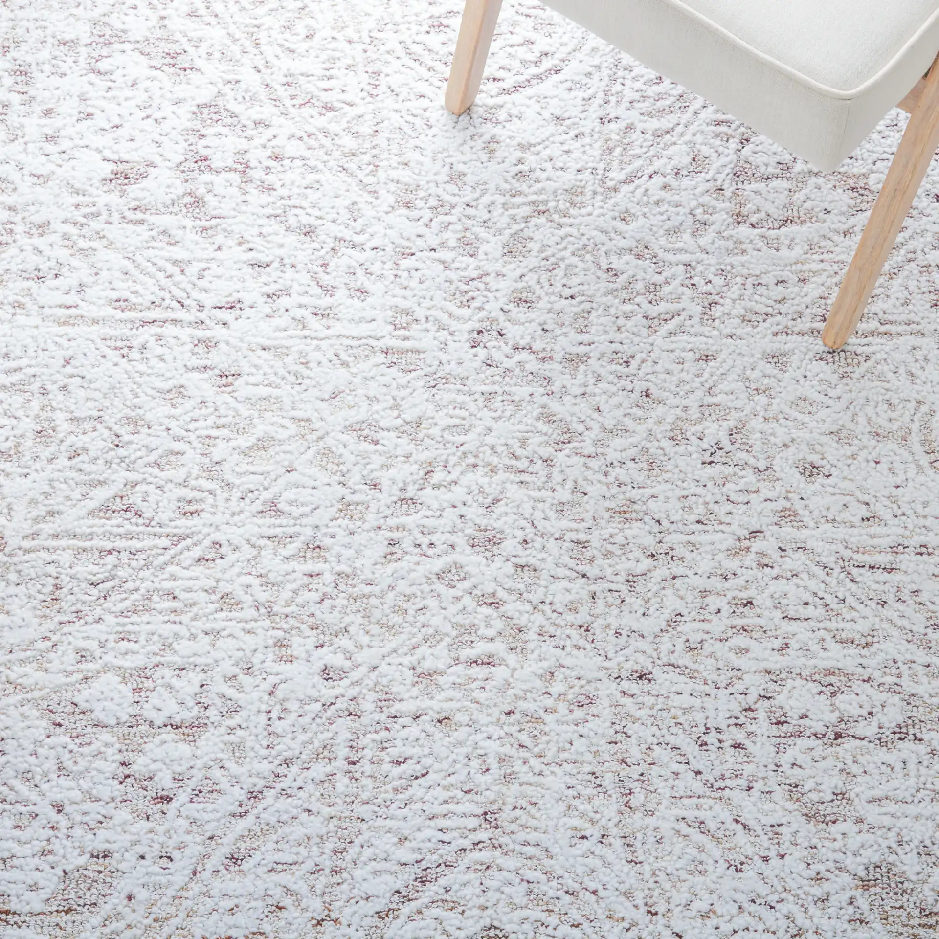 Metro Erased Medallion Hand-Tufted Wool Blend Rug in Ivory / Beige in a styled room