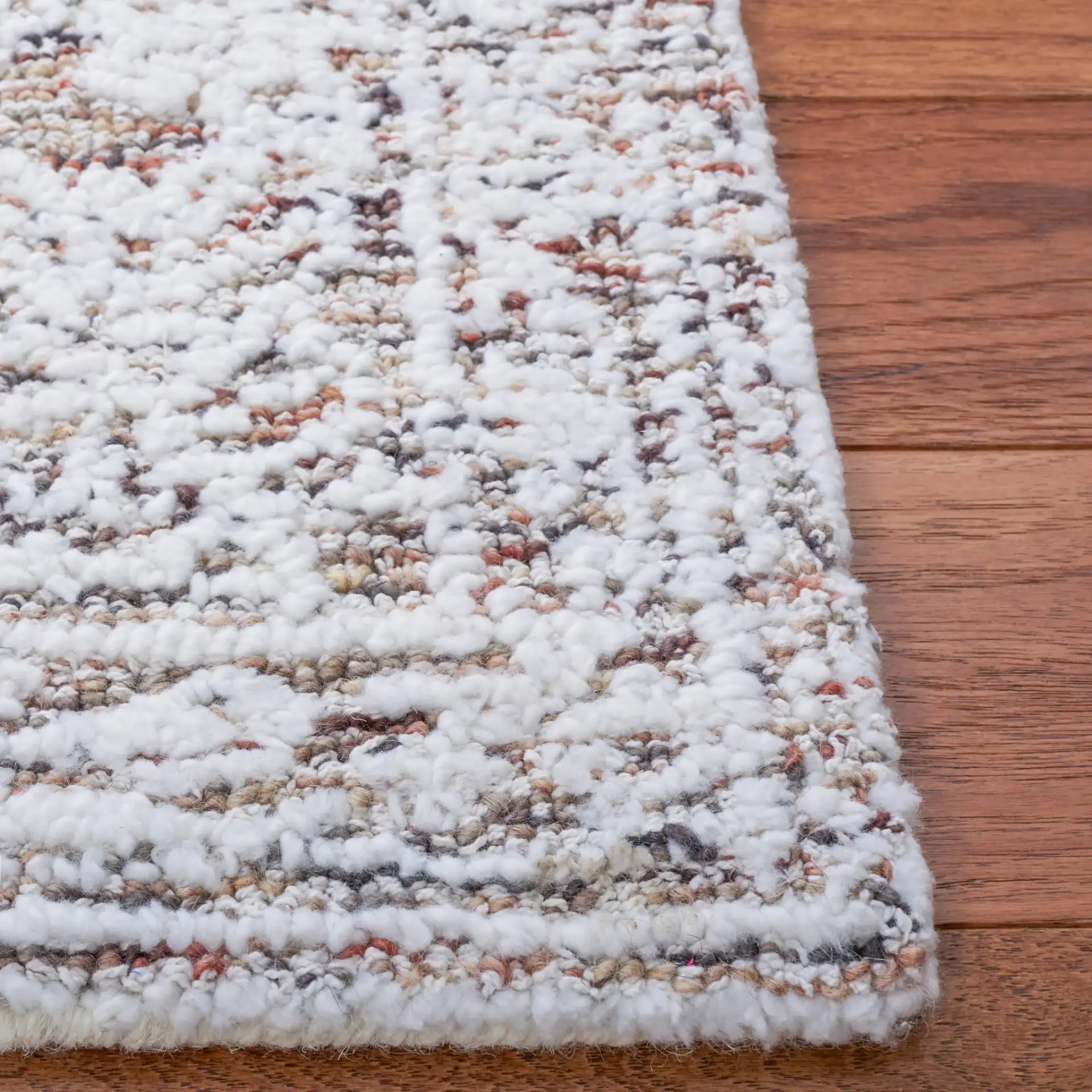 Metro Distressed Medallion Hand-Tufted Wool Blend Rug in Ivory / Rust in a styled room