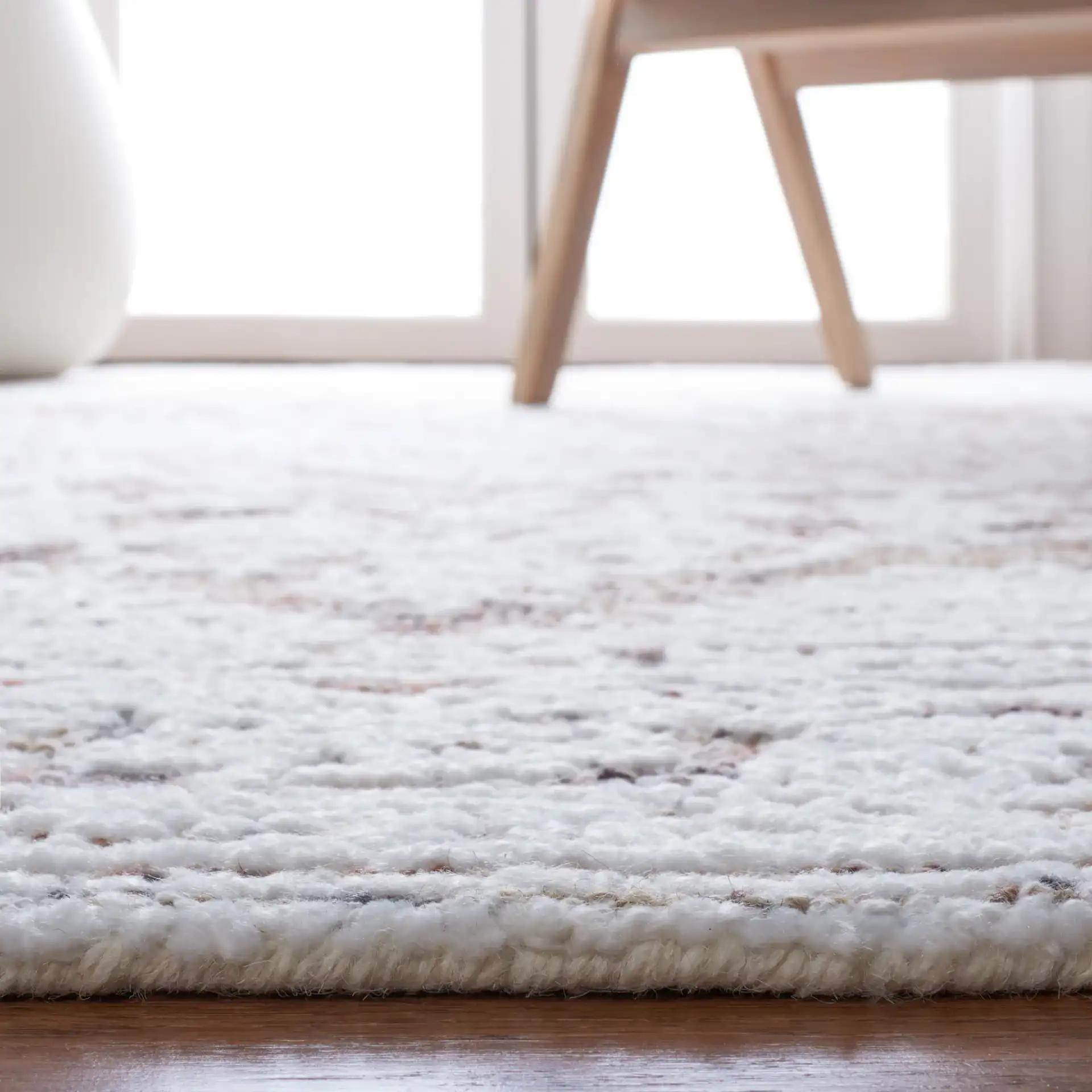 Metro Distressed Medallion Hand-Tufted Wool Blend Rug in Ivory / Rust in a styled room