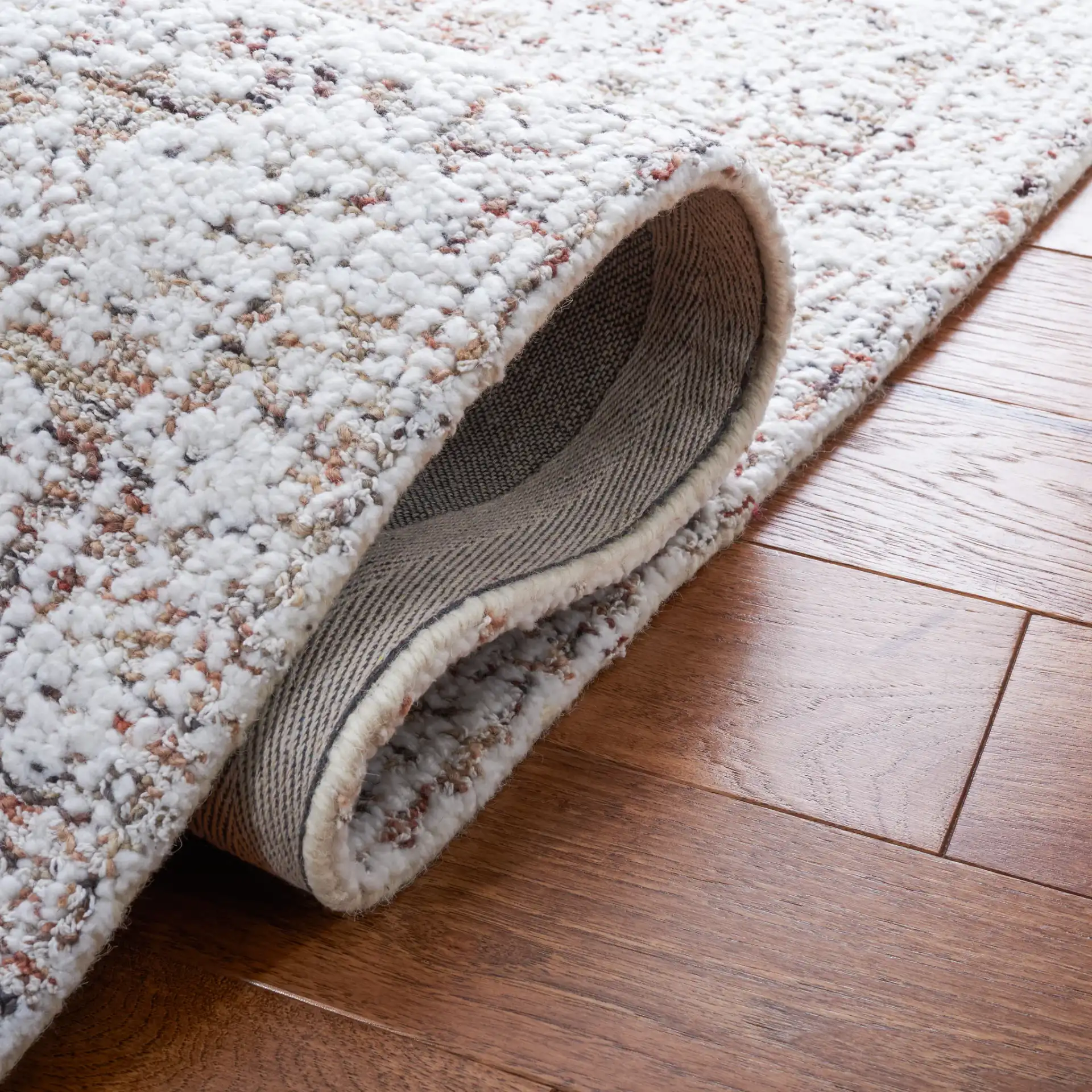 Metro Distressed Medallion Hand-Tufted Wool Blend Rug in Ivory / Rust in a styled room