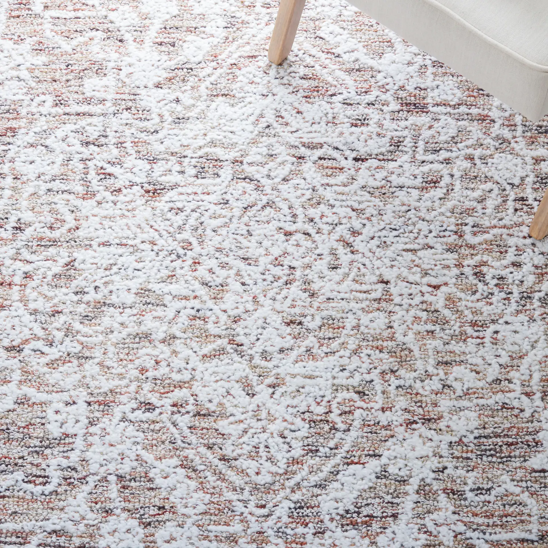 Metro Distressed Medallion Hand-Tufted Wool Blend Rug in Ivory / Rust in a styled room