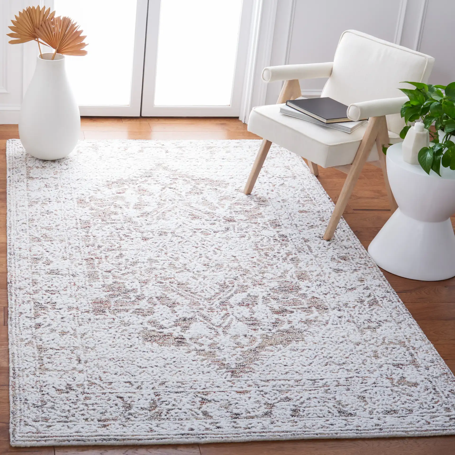 Metro Distressed Medallion Hand-Tufted Wool Blend Rug in Ivory / Rust in a styled room