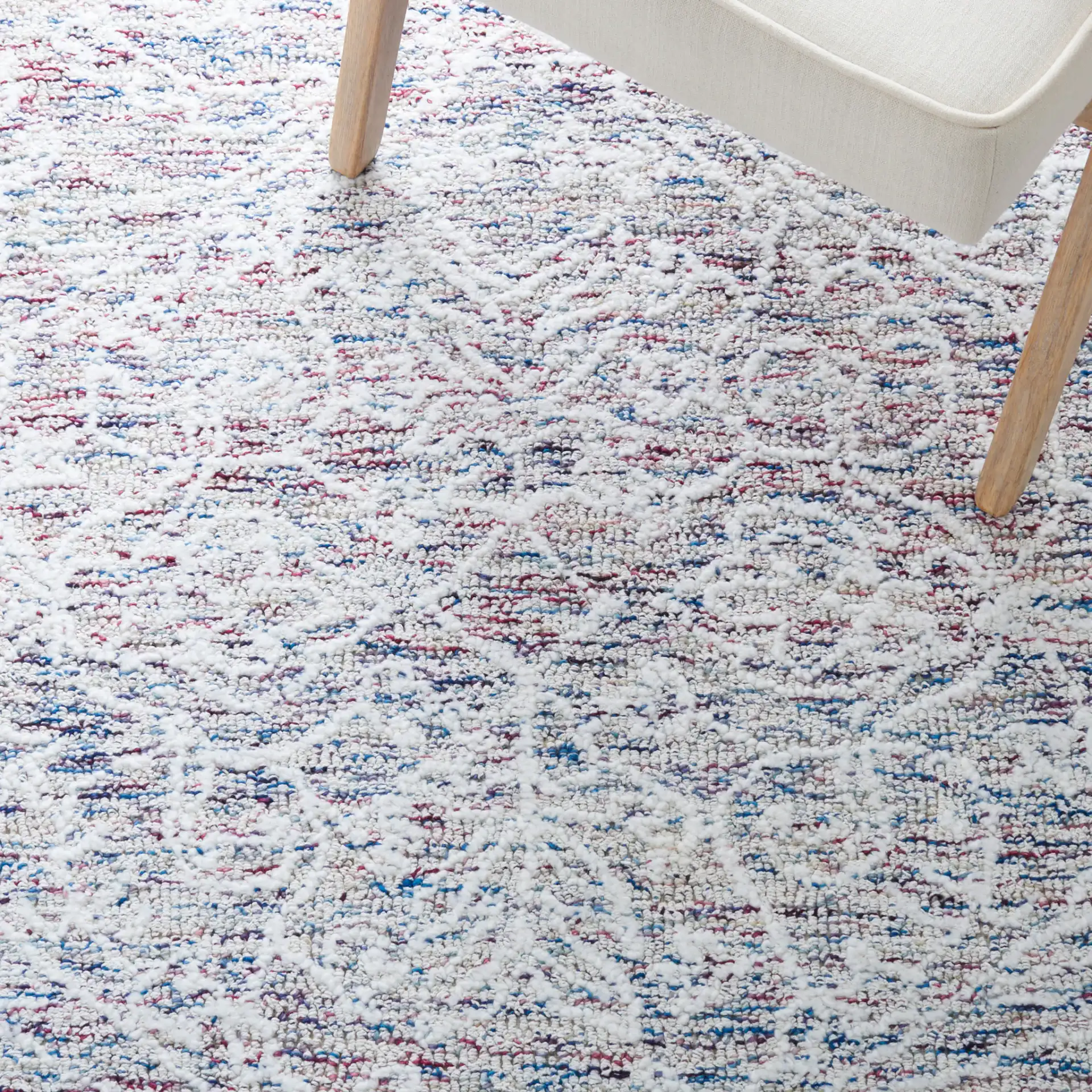 Metro Distressed Diamond Hand-Tufted Wool Blend Rug in Ivory / Red in a styled room