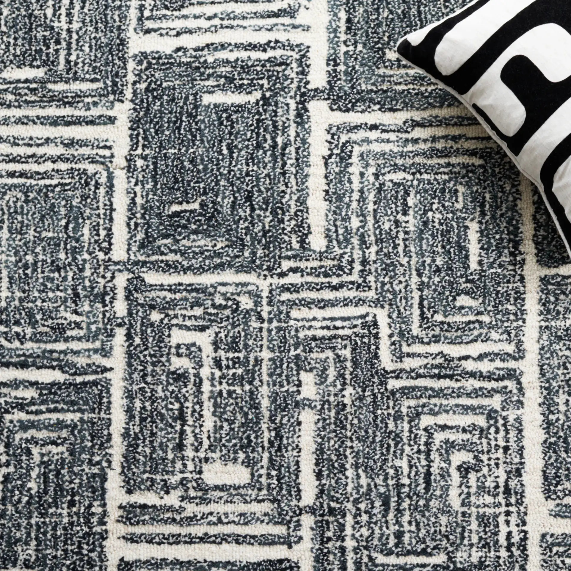 Metro Interlocking Block Hand-Tufted Wool Rug in Black / Ivory in a styled room