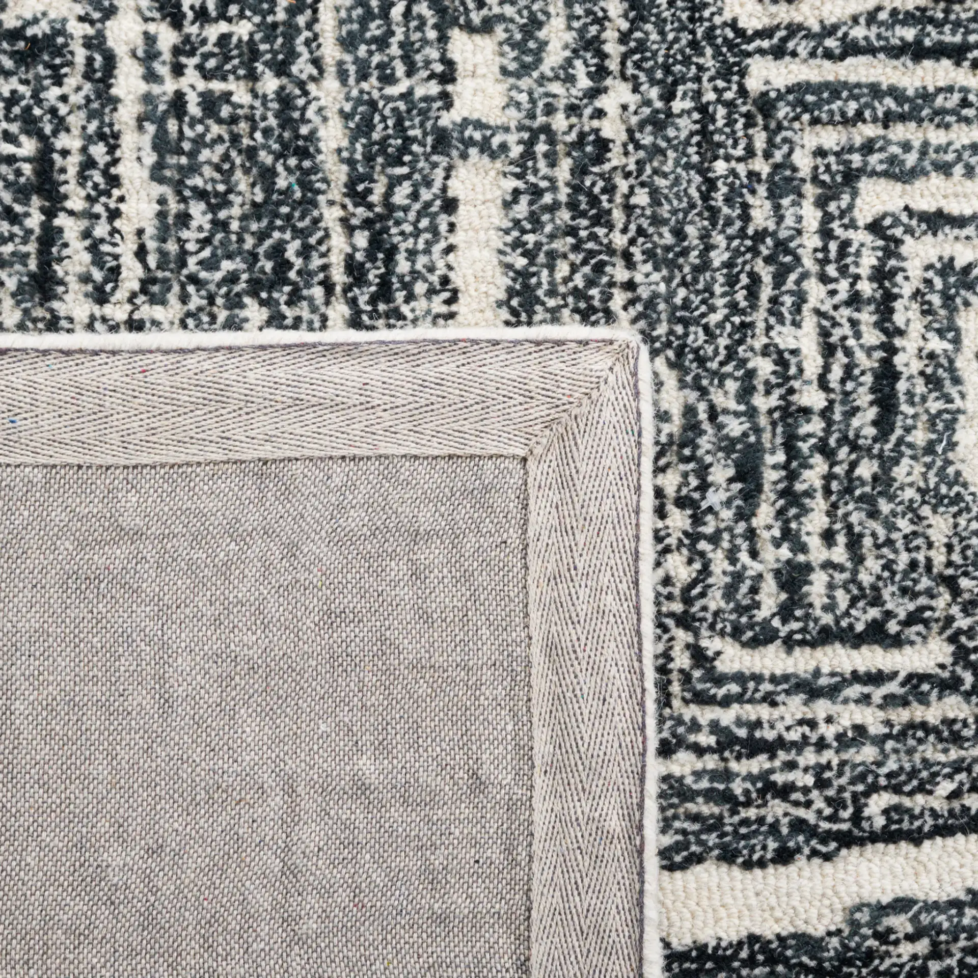 Metro Interlocking Block Hand-Tufted Wool Rug in Black / Ivory in a styled room