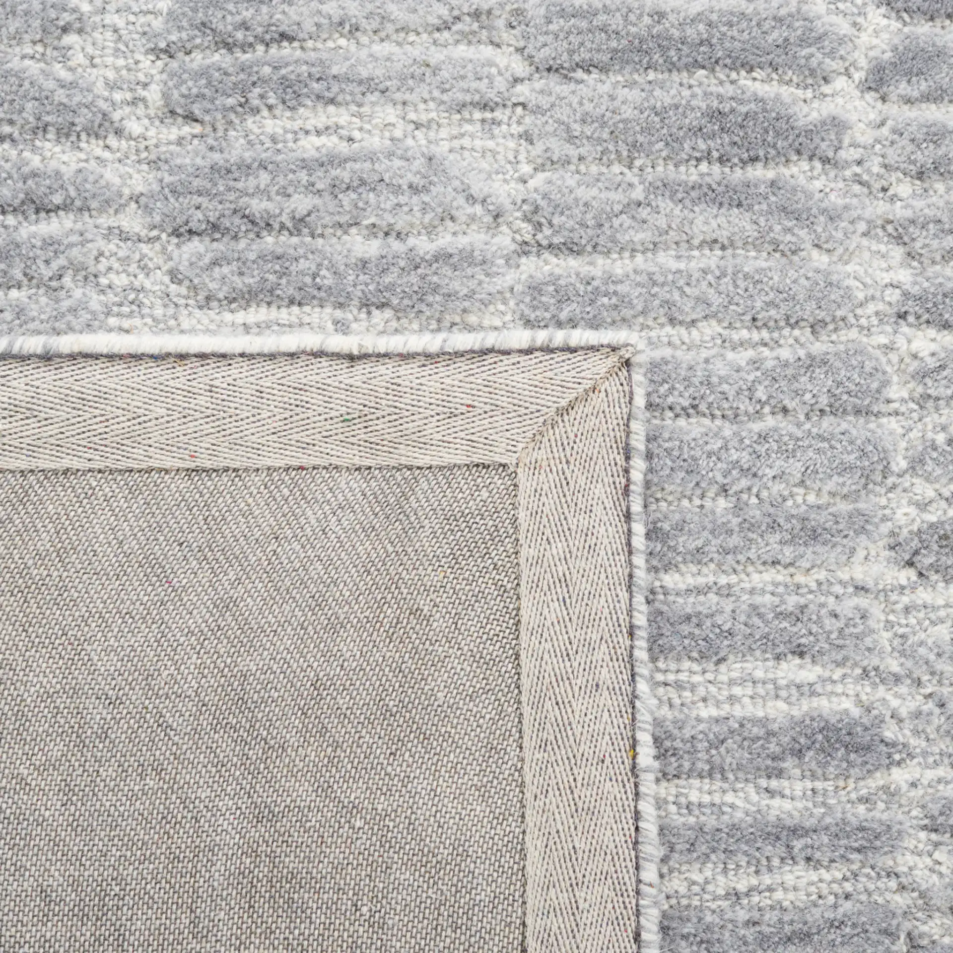 Metro Dashed Stripe Hand-Tufted Wool Rug in Silver / Gray in a styled room