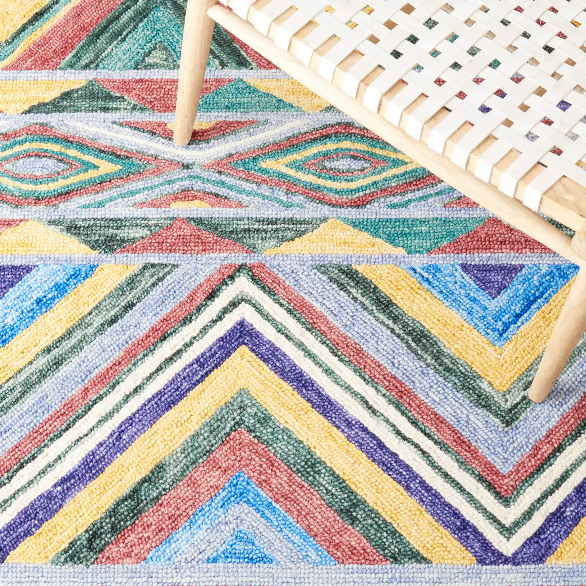 Metro Southwestern Chevron Hand-Tufted Wool Rug in Red / Blue in a styled room