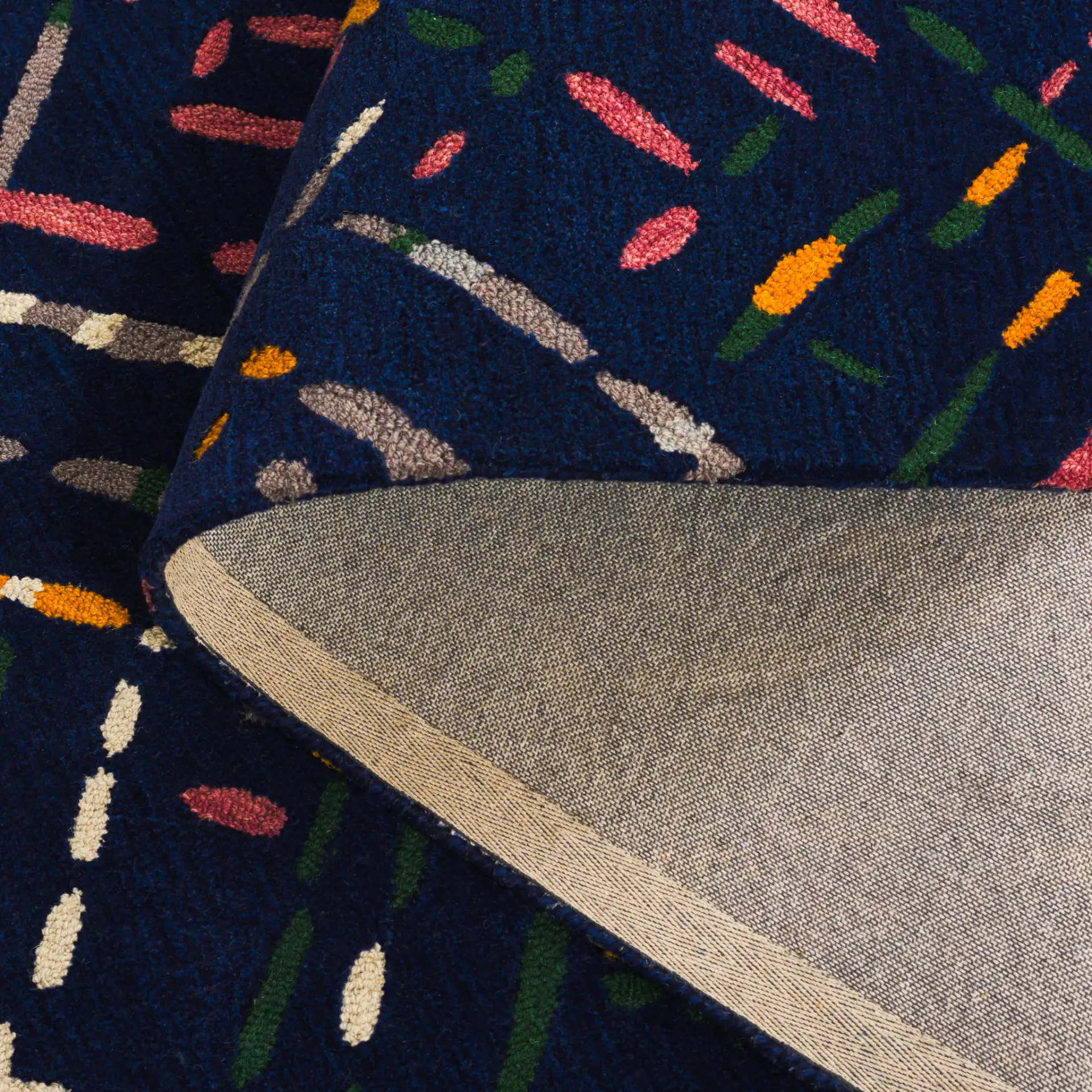 Metro Abstract Dash Hand-Tufted Wool Rug in Navy / Pink in a styled room