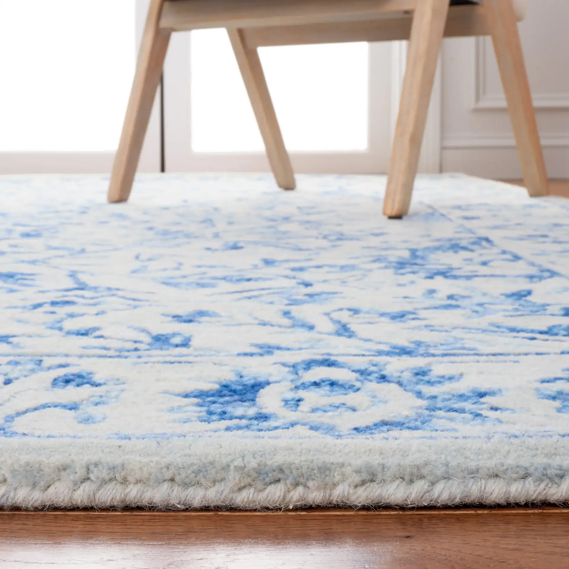 Metro Floral Arabesque Hand-Tufted Wool Rug in Blue / Beige in a styled room