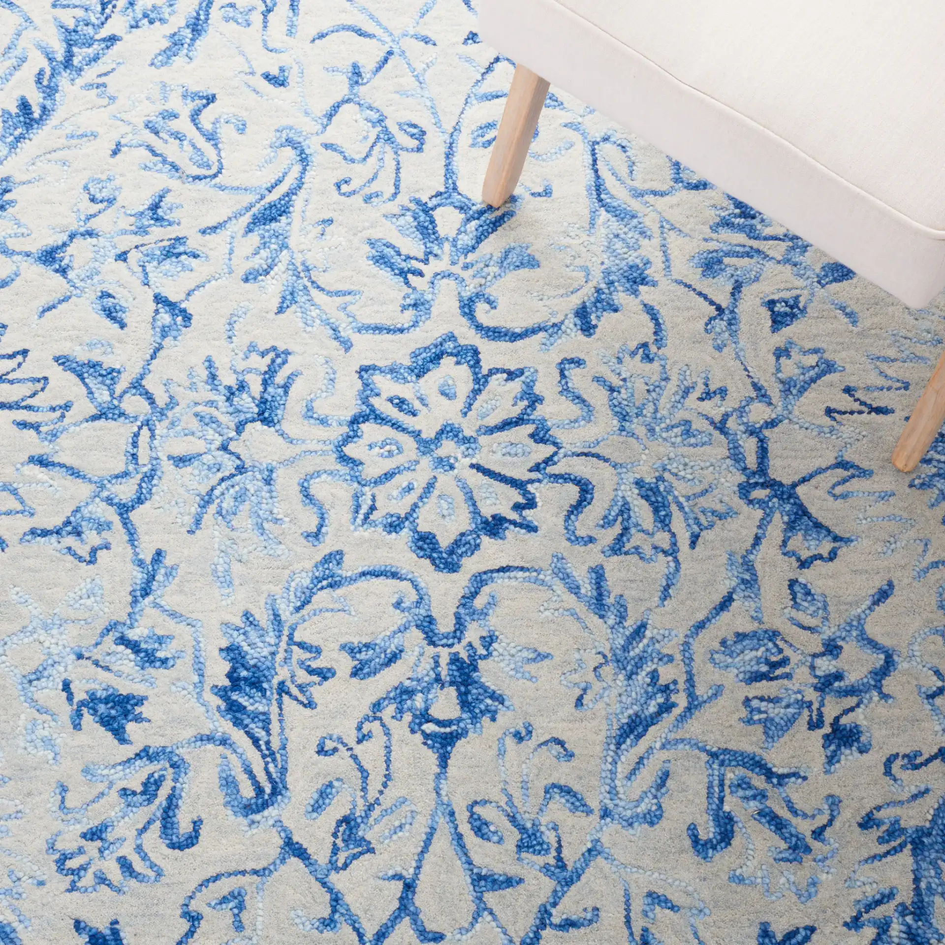 Metro Floral Arabesque Hand-Tufted Wool Rug in Blue / Beige in a styled room