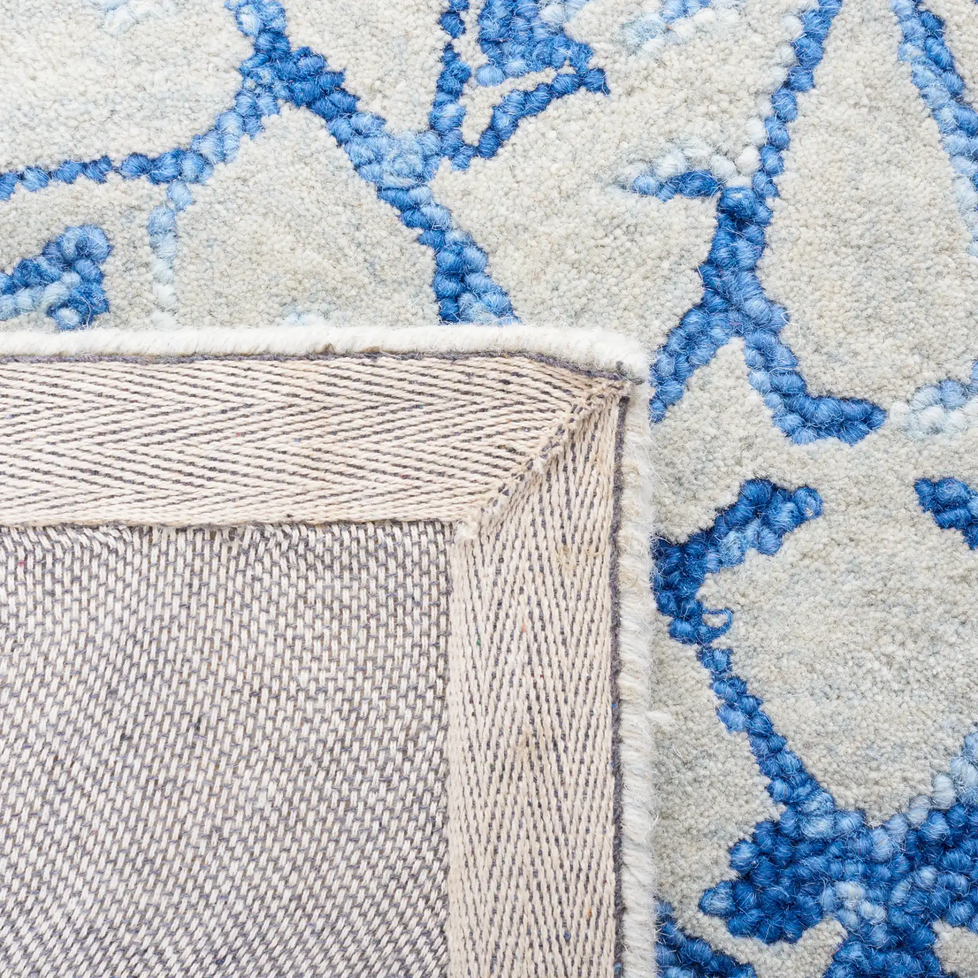Metro Floral Arabesque Hand-Tufted Wool Rug in Blue / Beige in a styled room
