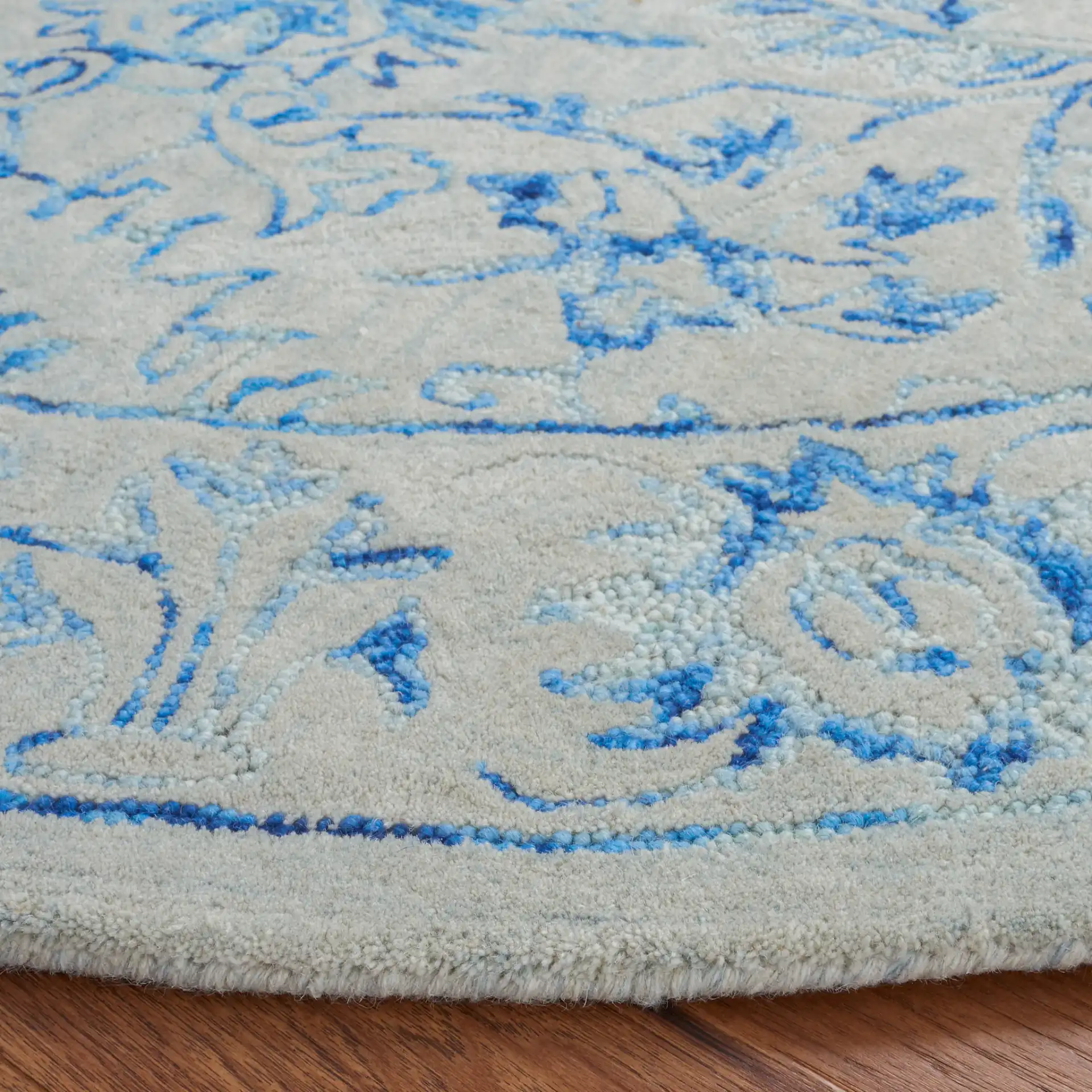 Metro Floral Arabesque Hand-Tufted Wool Rug in Blue / Beige in a styled room