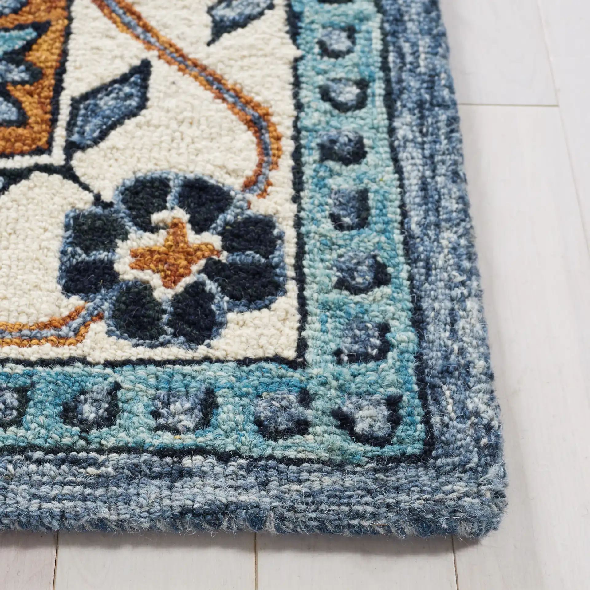 Metro Concentric Stepped Medallion Hand-Tufted Wool Rug in Blue / Ivory in a styled room