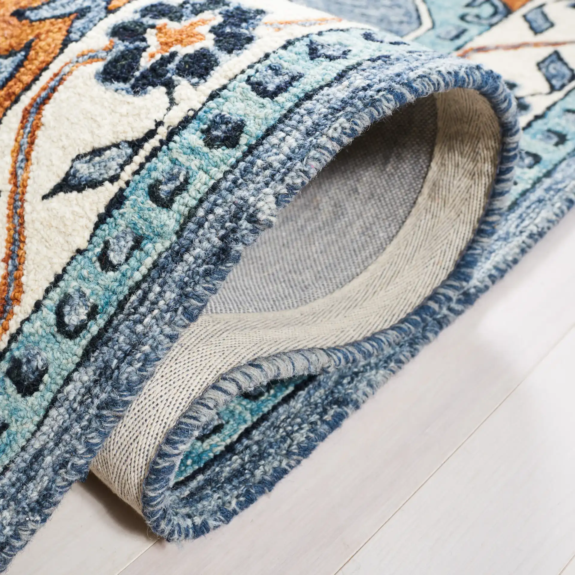 Metro Concentric Stepped Medallion Hand-Tufted Wool Rug in Blue / Ivory in a styled room