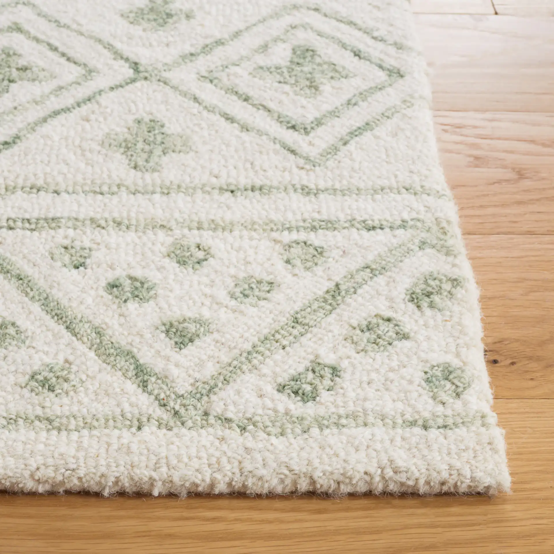Metro Geometric Banded Hand-Tufted Wool Rug in Ivory / Light Green in a styled room