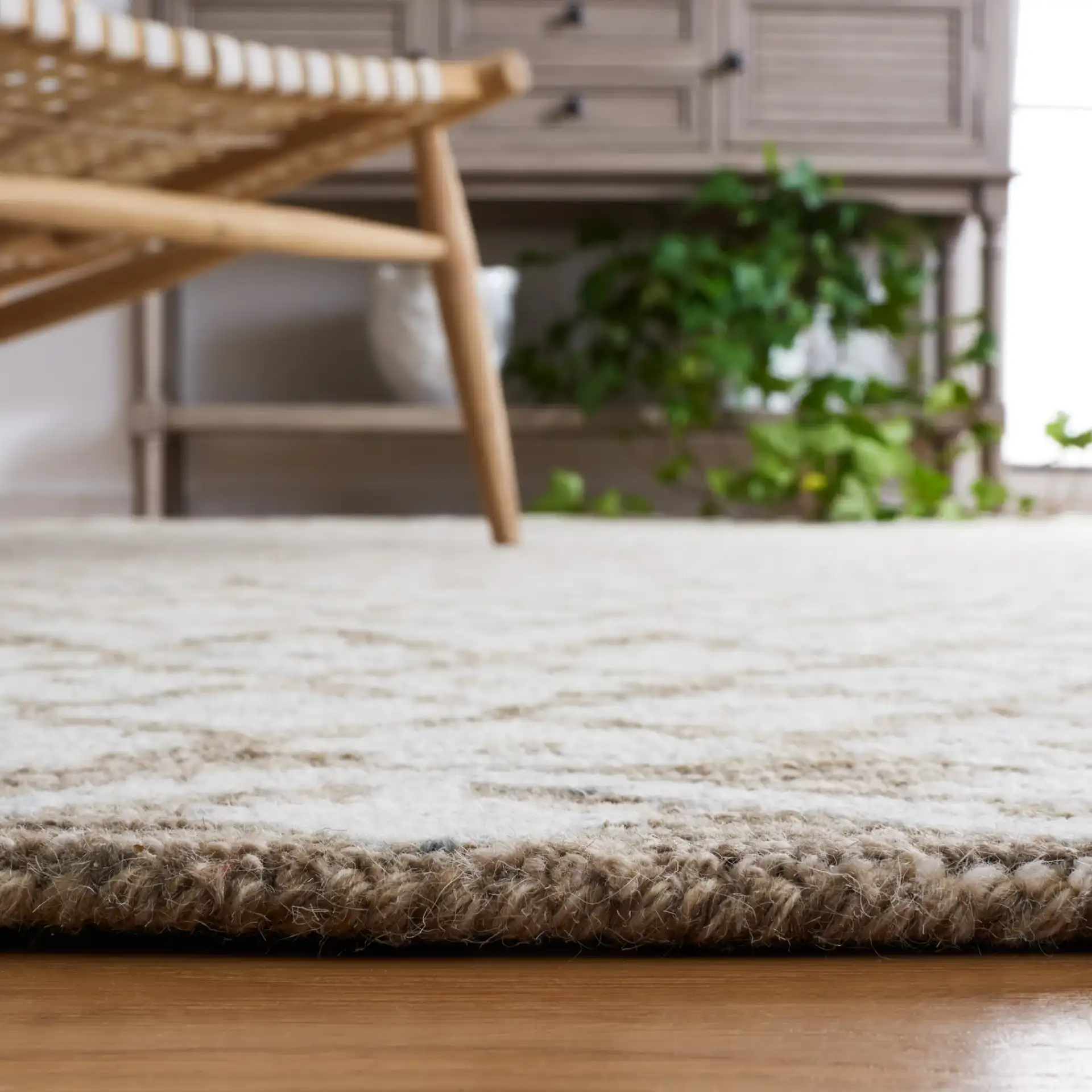 Metro Trellis Border Hand-Tufted Wool Rug in Beige / Sage in a styled room
