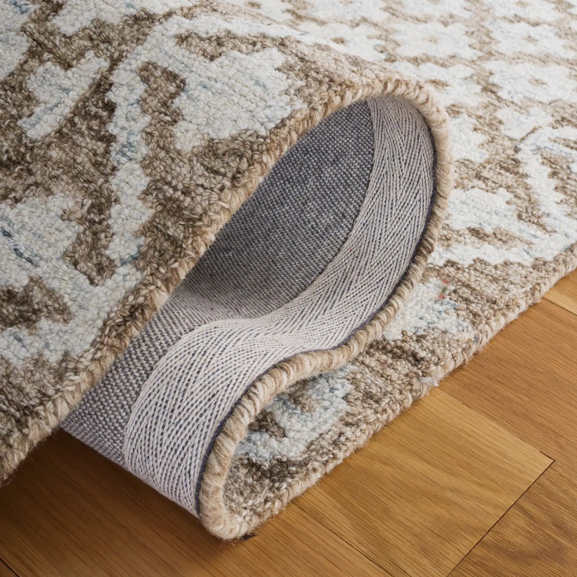 Metro Trellis Border Hand-Tufted Wool Rug in Beige / Sage in a styled room