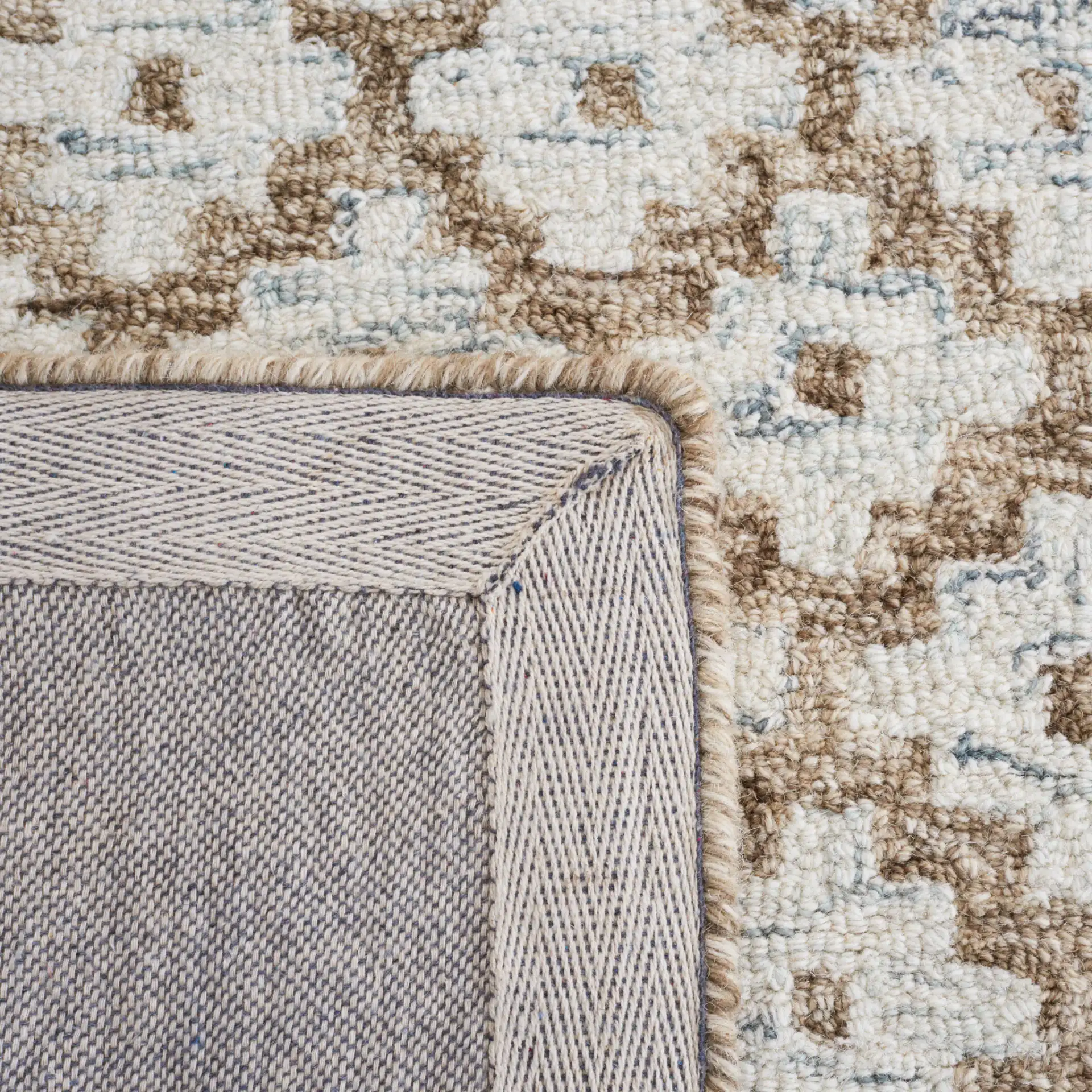 Metro Trellis Border Hand-Tufted Wool Rug in Beige / Sage in a styled room