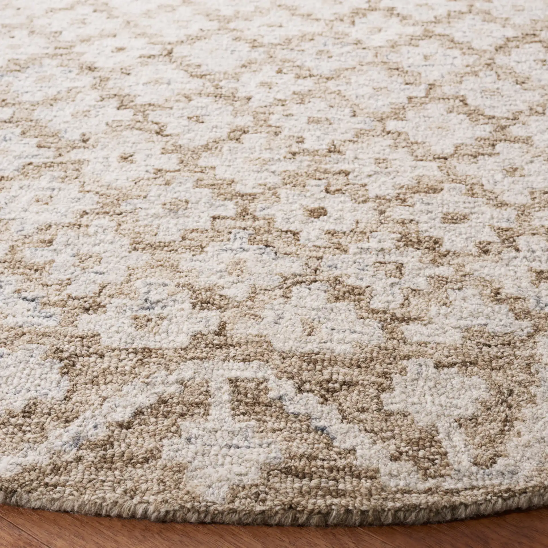 Metro Trellis Border Hand-Tufted Wool Rug in Beige / Sage in a styled room
