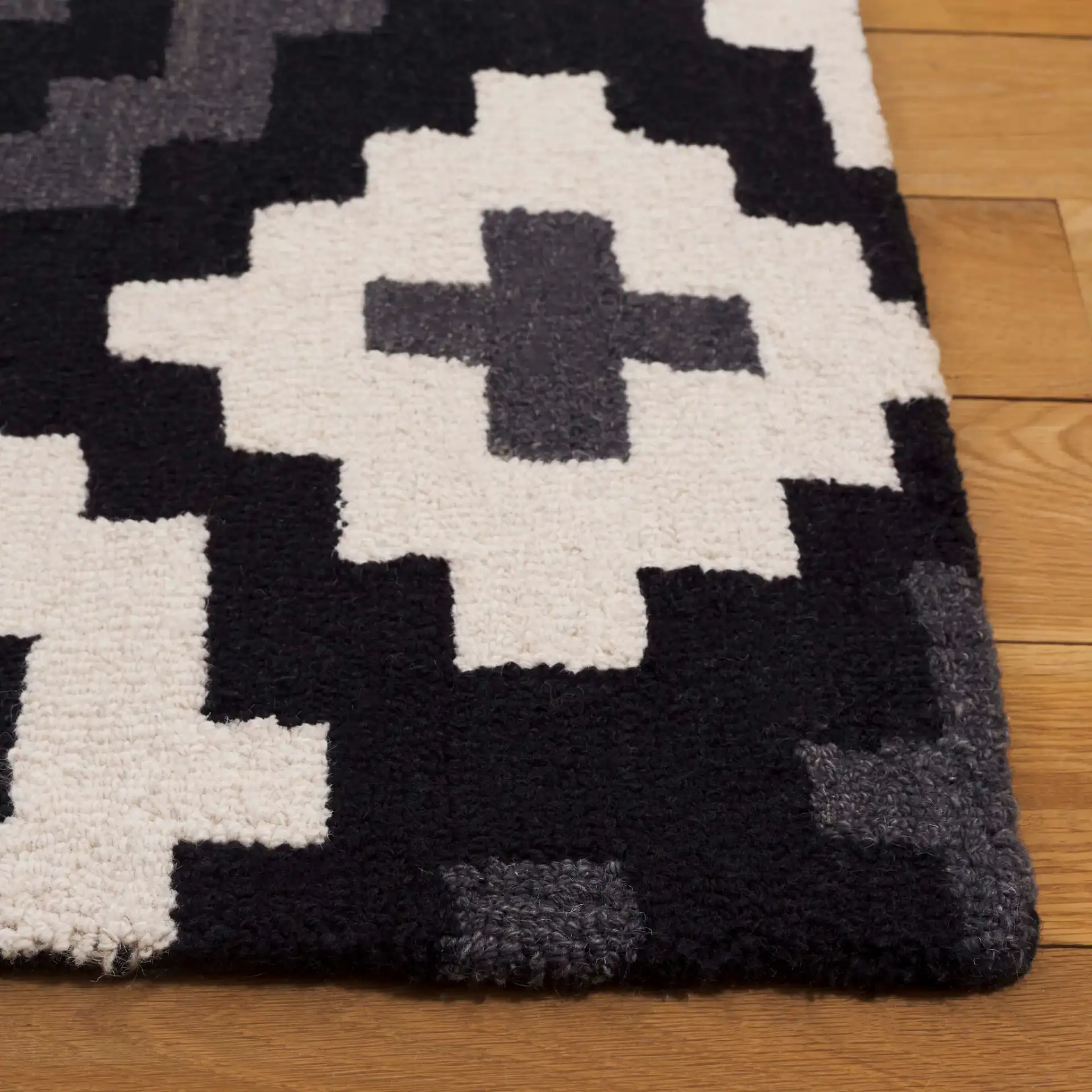 Metro Stepped Geometric Hand-Tufted Wool Rug in Black / Ivory in a styled room