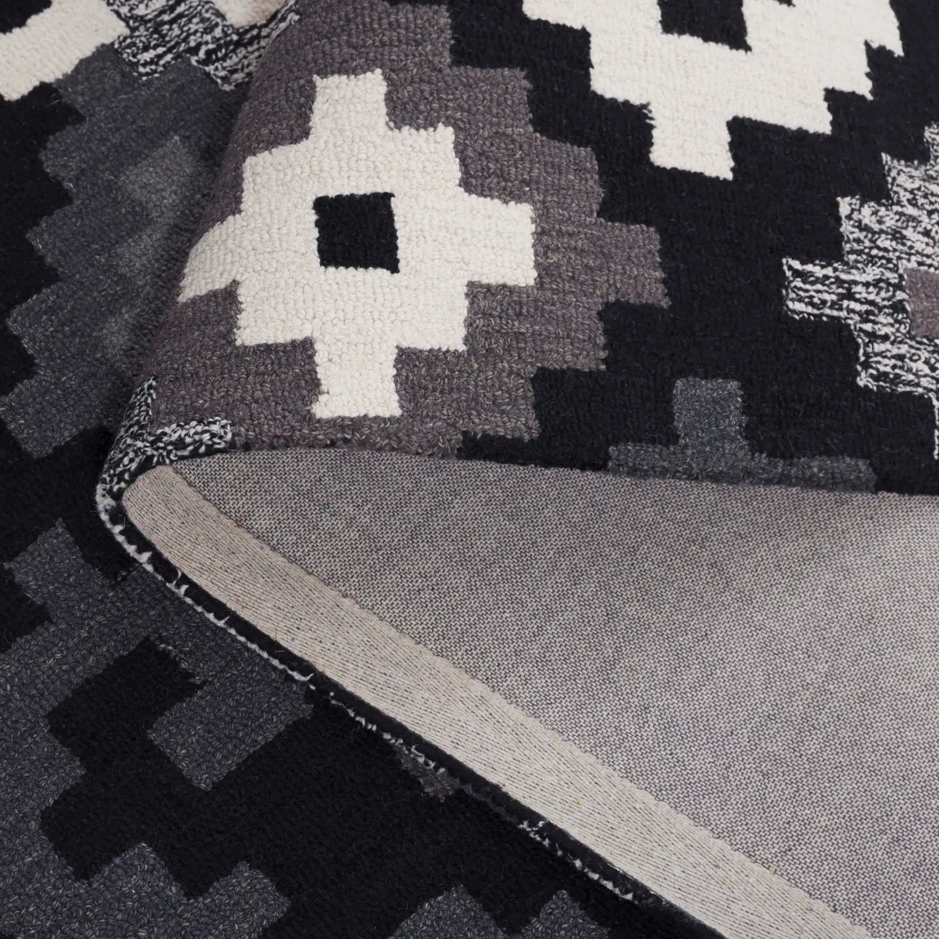 Metro Stepped Geometric Hand-Tufted Wool Rug in Black / Ivory in a styled room
