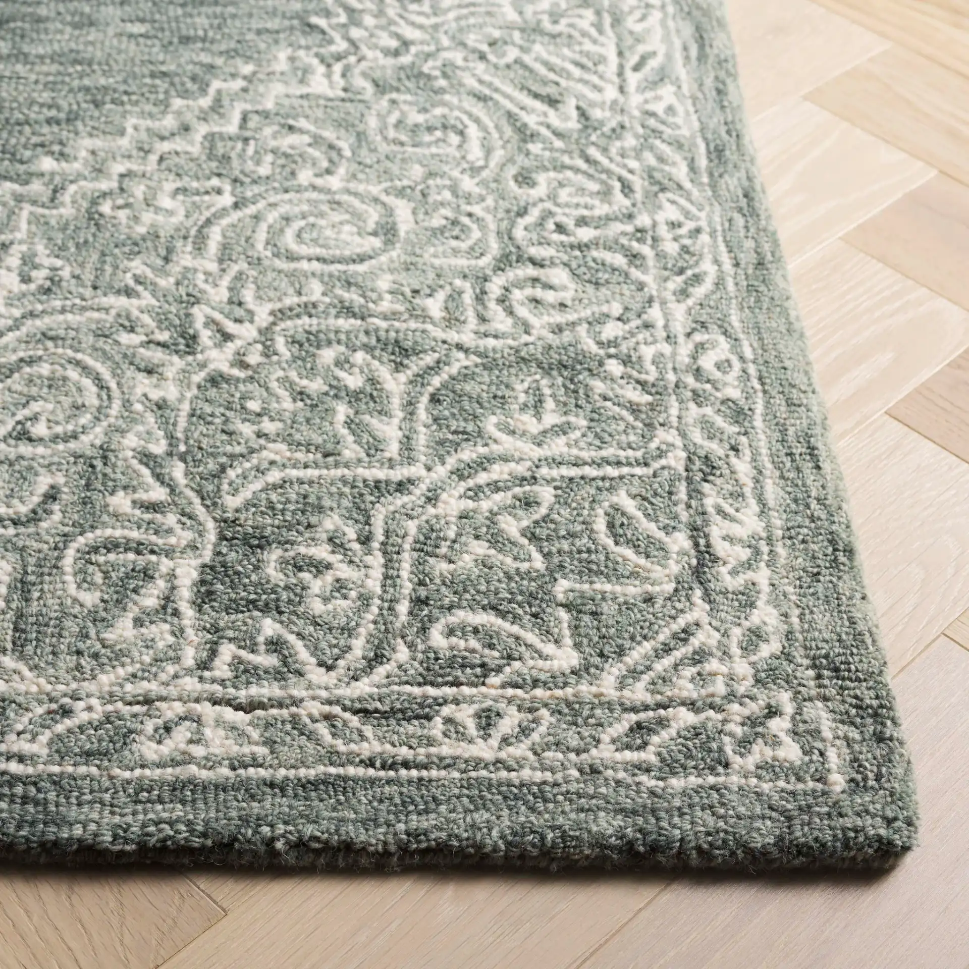 Metro Linear Medallion Hand-Tufted Wool Rug in Green / Ivory in a styled room
