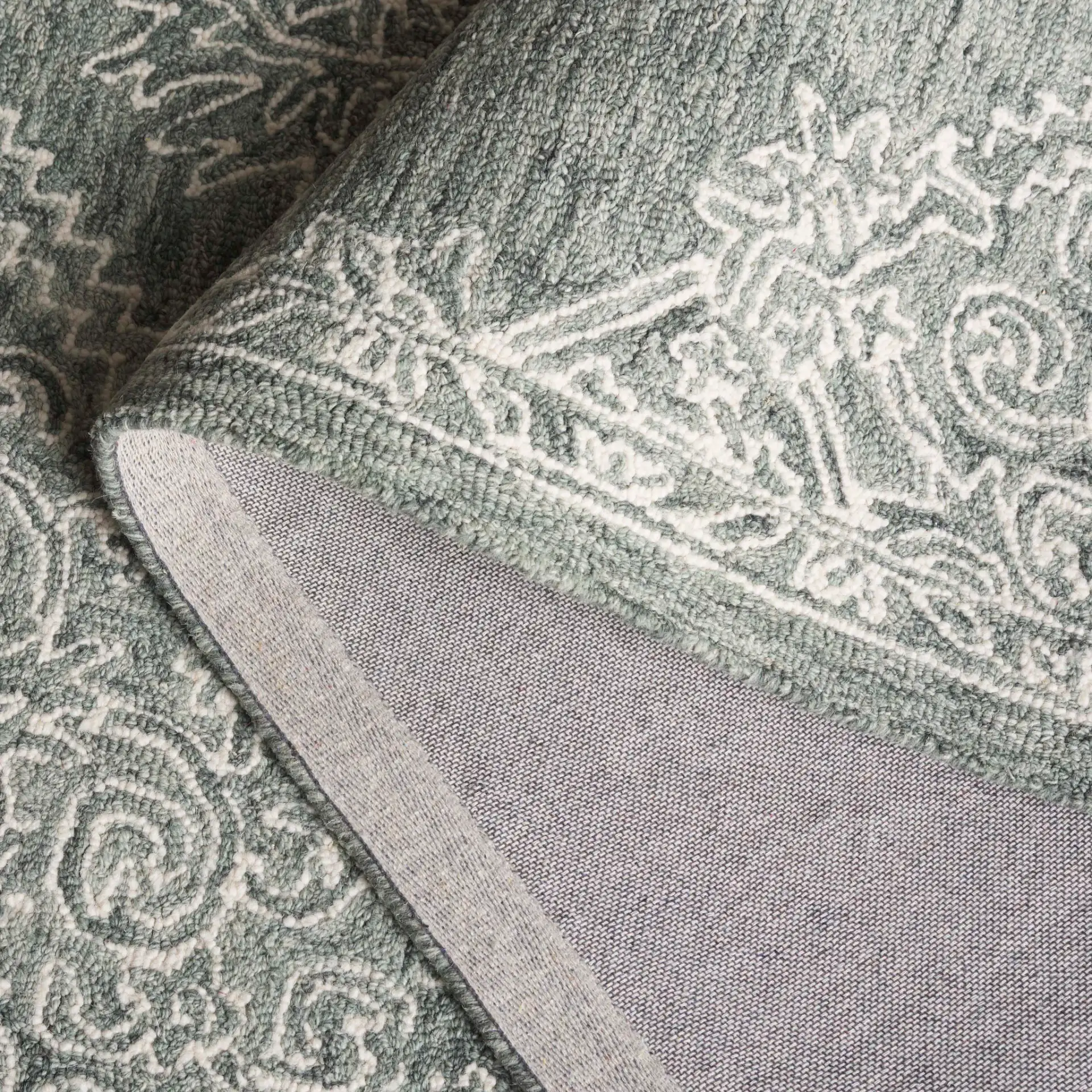 Metro Linear Medallion Hand-Tufted Wool Rug in Green / Ivory in a styled room
