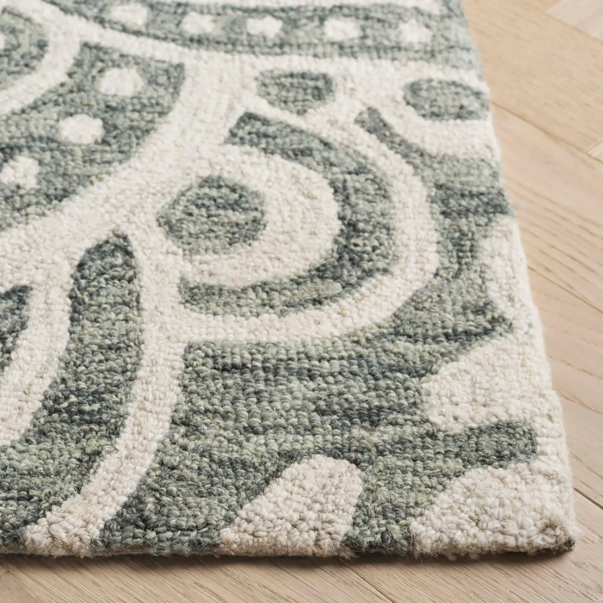 Metro Mandala Medallion Hand-Tufted Wool Rug in Green / Ivory in a styled room