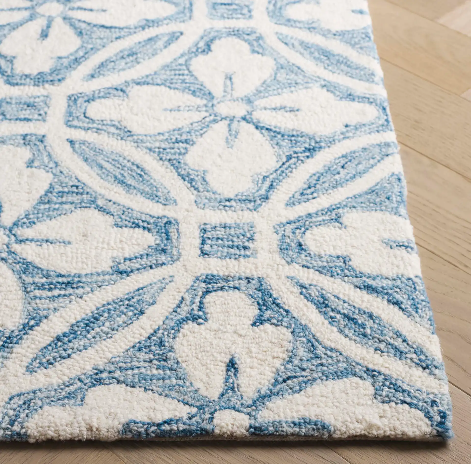 Metro Floral Tile Hand-Tufted Wool Rug in Ivory / Blue in a styled room