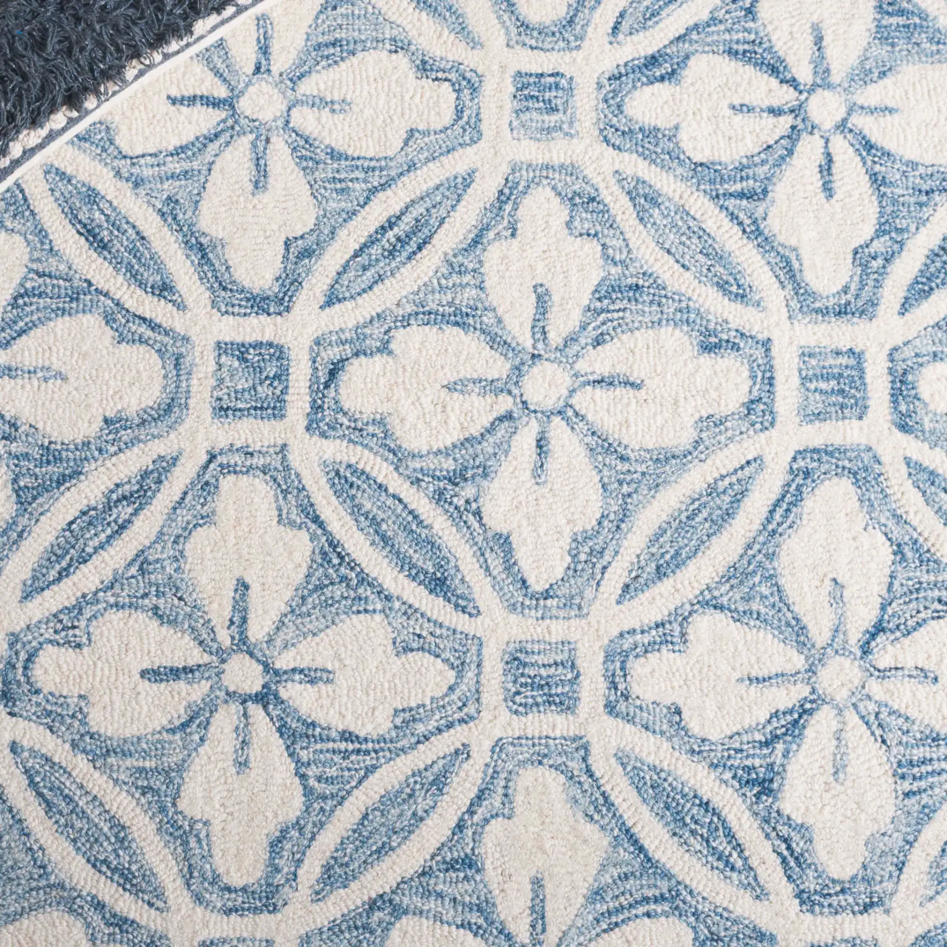 Metro Floral Tile Hand-Tufted Wool Rug in Ivory / Blue in a styled room