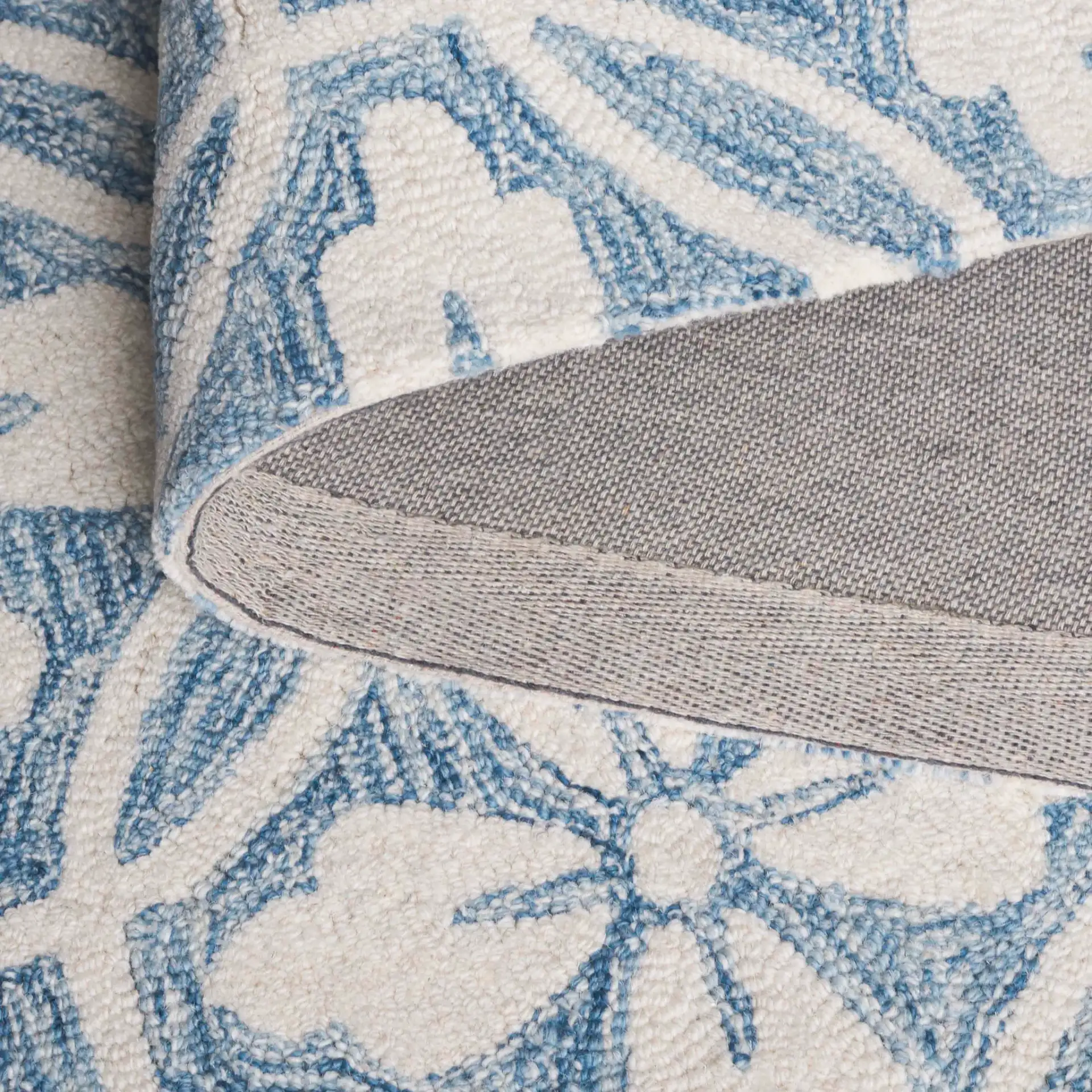 Metro Floral Tile Hand-Tufted Wool Rug in Ivory / Blue in a styled room