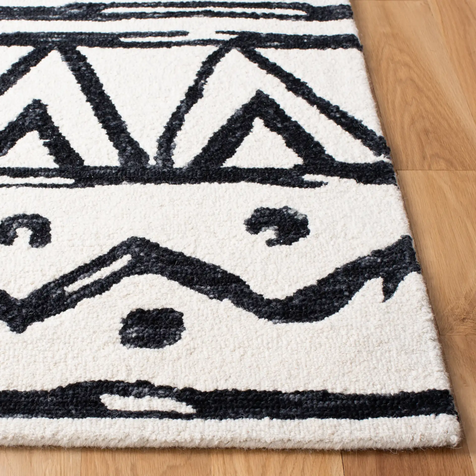 Metro Tribal Motif Stripe Hand-Tufted Wool Rug in Black / Ivory in a styled room