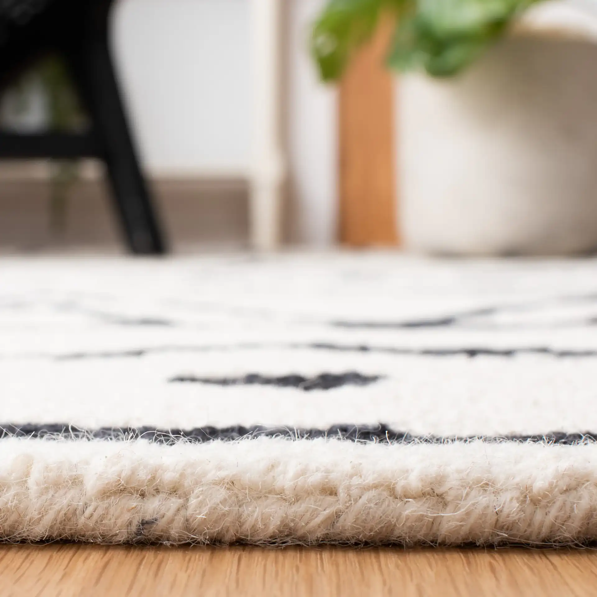 Metro Tribal Motif Stripe Hand-Tufted Wool Rug in Black / Ivory in a styled room